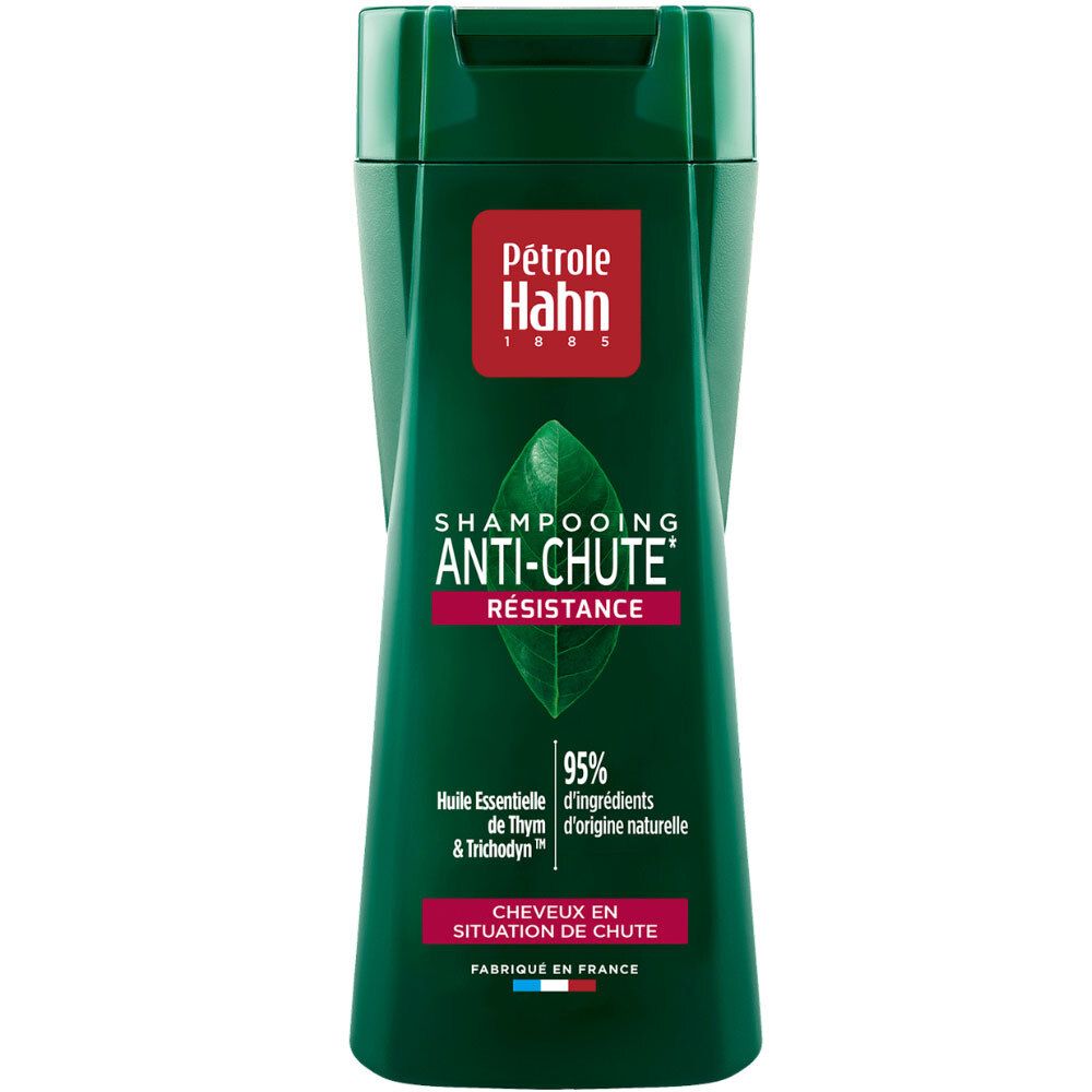 Shampoing Anti-Chute Petrole Hahn: Flacon vert avec étiquette rouge, motif feuille et texte.