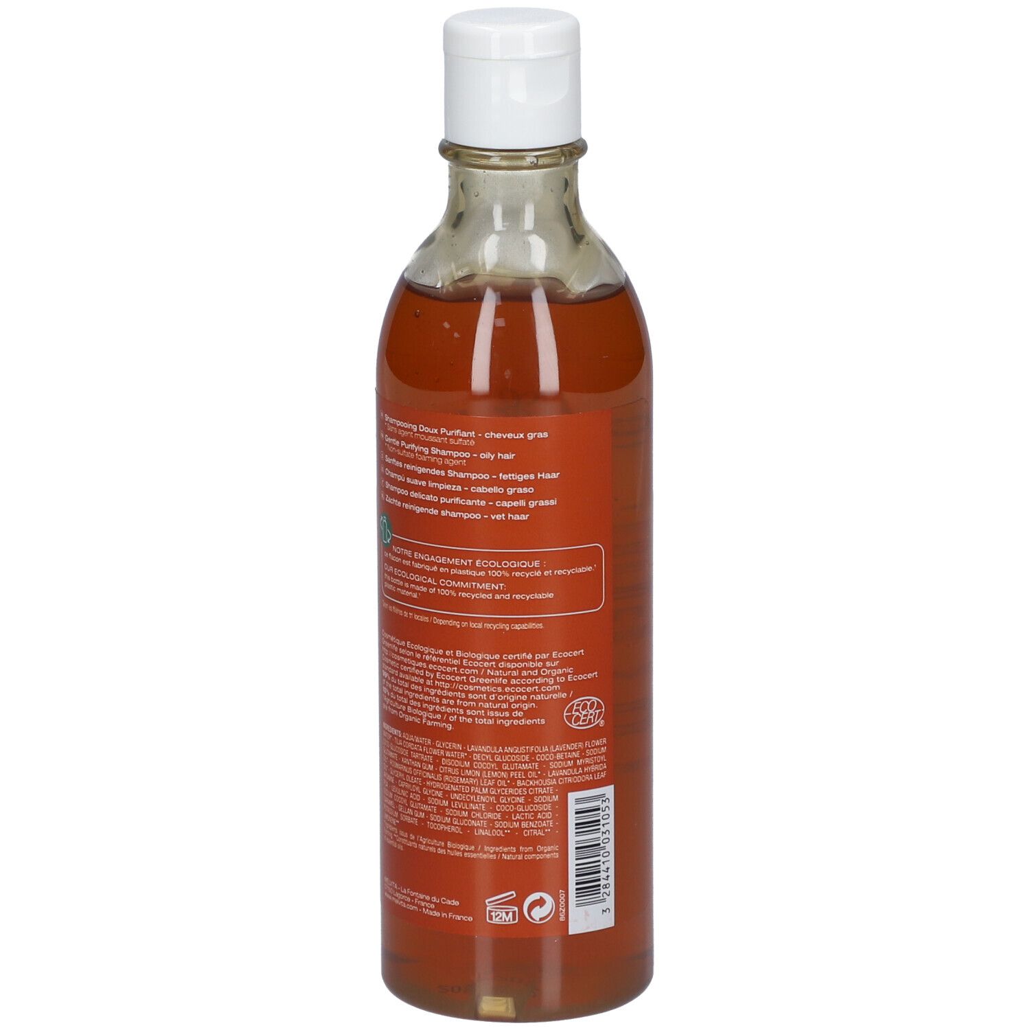 Bouteille transparente avec liquide brun et bouchon blanc. Dos avec texte et logo.