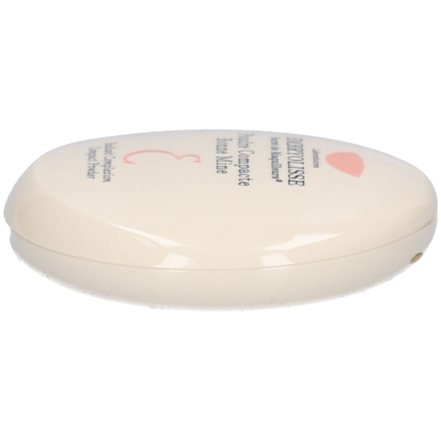 Boîtier de poudre compacte ovale, crème. Inscription: EMBRYOLISSE, Poudre Compacte Bonne Mine. Logo rose.