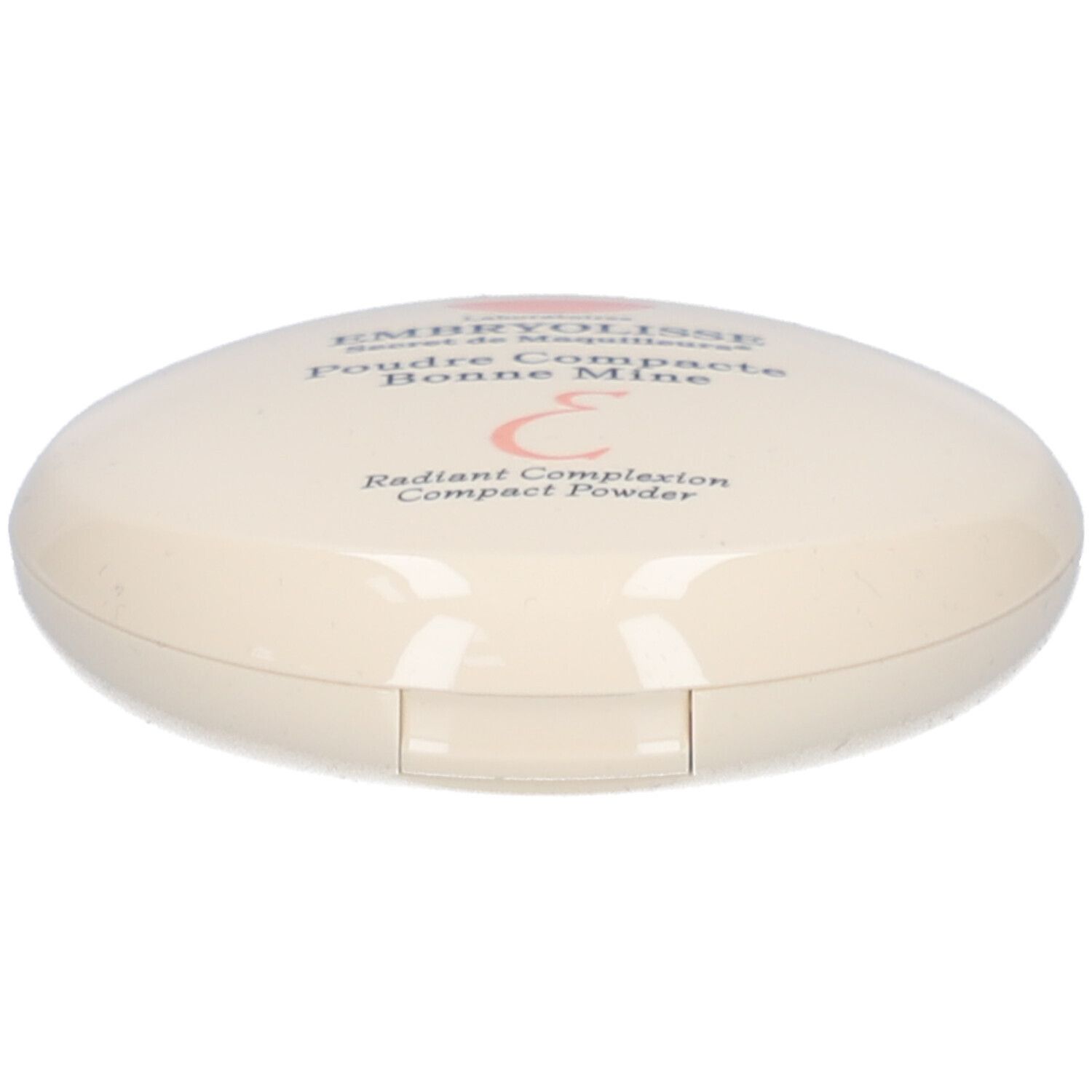 Boîtier de poudre compacte ovale, crème. Inscription: EMBRYOLISSE, Poudre Compacte Bonne Mine. Logo rose.
