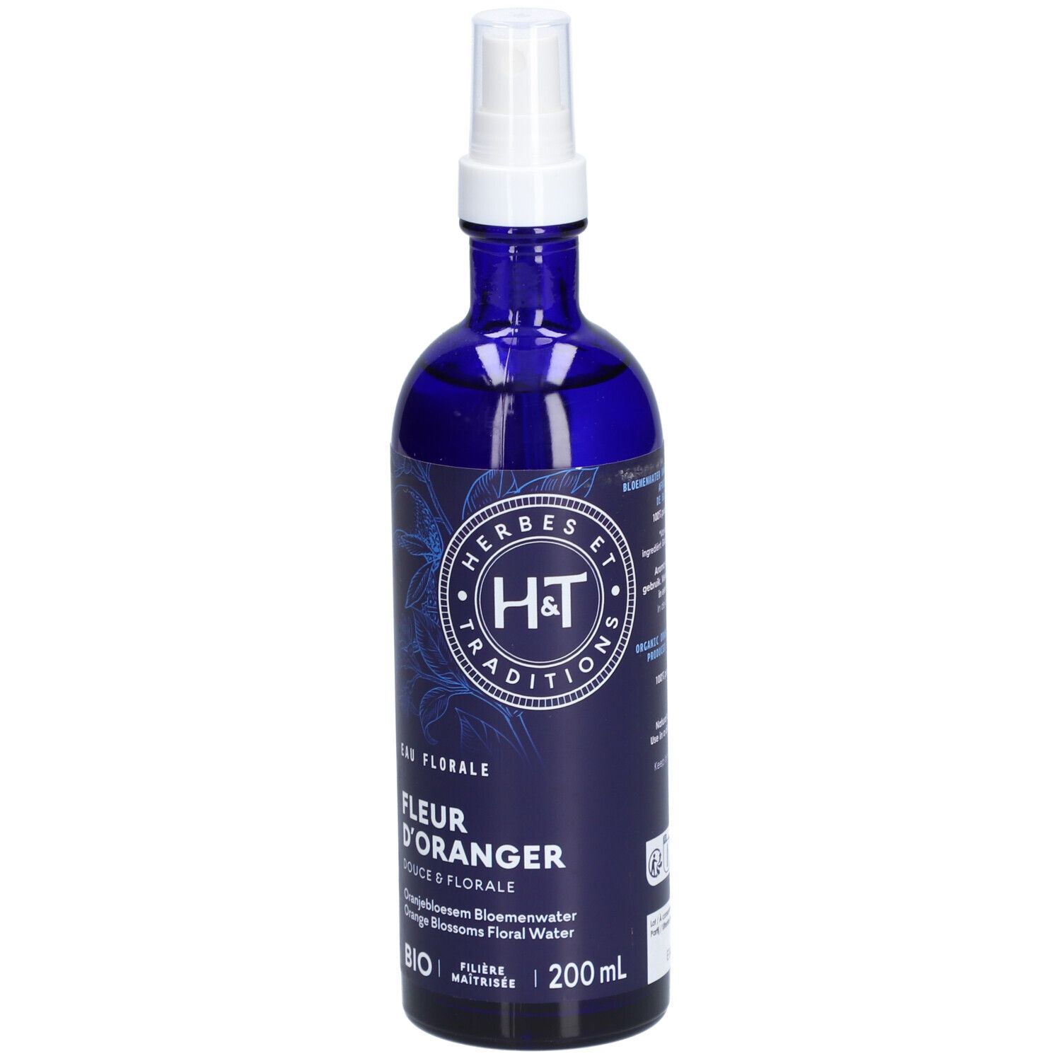 Flacon en verre bleu avec vaporisateur blanc. Étiquette avec logo et texte: FLEUR D'ORANGER BIO. 200ml.