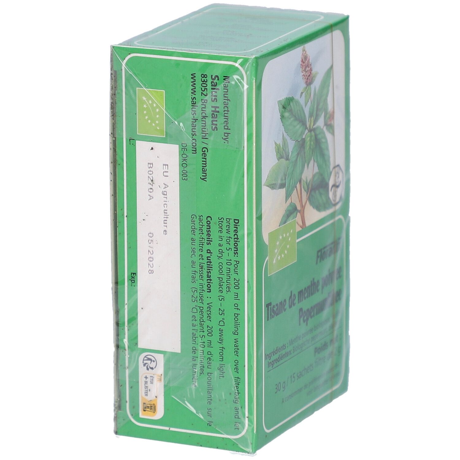 Boîte de thé verte, partiellement emballée. Inscriptions: Tisane de menthe poivrée, Pepermuntthee. Label bio. Texte et date de péremption.
