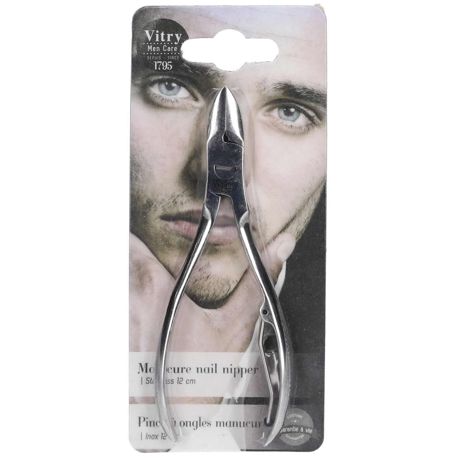 Pince à ongles en acier inoxydable, emballée. Logo Vitry et visage d'homme sur l'emballage. Pince argentée.