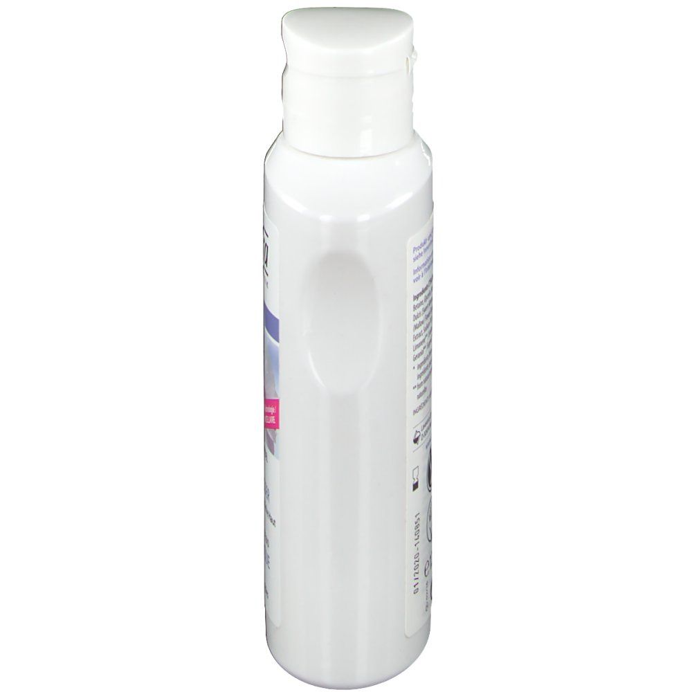 Flacon blanc avec bouchon rabattable, vue latérale. Étiquette partiellement visible.