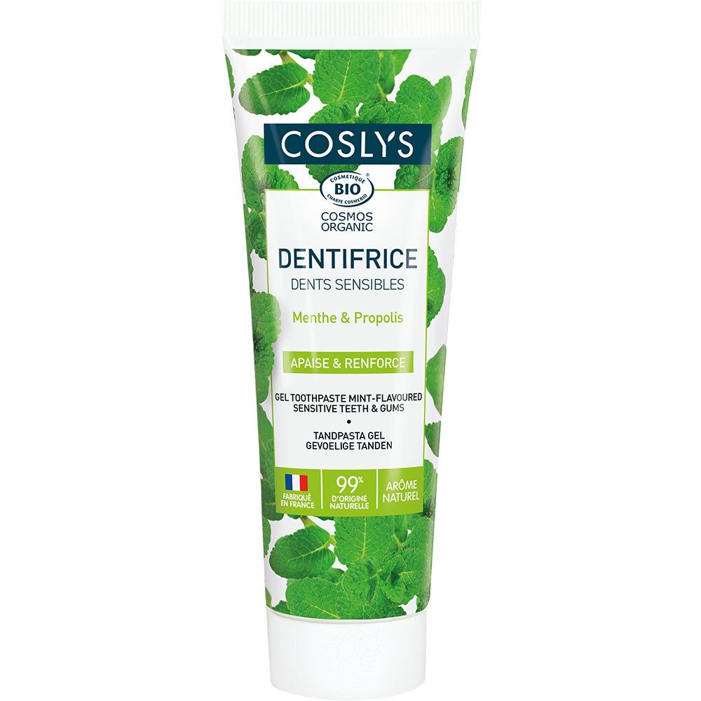 Tube de dentifrice avec feuilles vertes. Inscription: COSLYS, Dents Sensibles, Menthe & Propolis. Certification Bio.