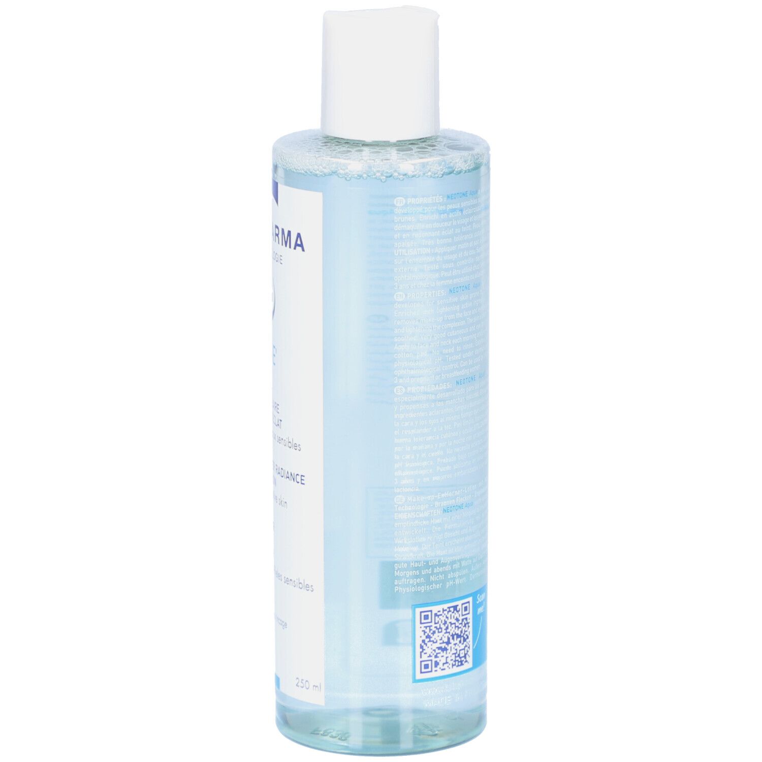 Dos d'un flacon transparent de solution pour la peau. Texte et code-barres visibles. Bouchon blanc.