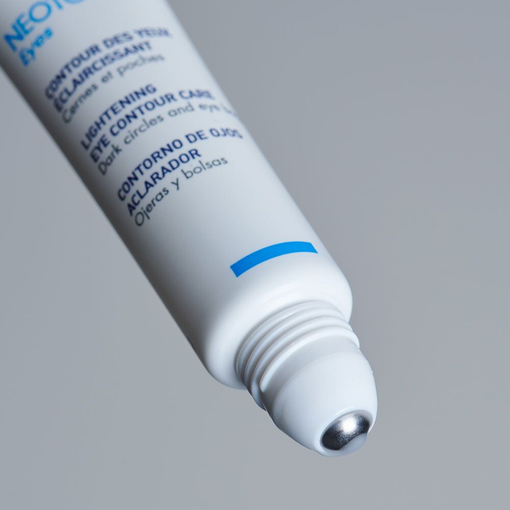 Tube blanc avec applicateur roll-on. Nom du produit: NEOTONE Eyes. Texte multilingue. Bande bleue.
