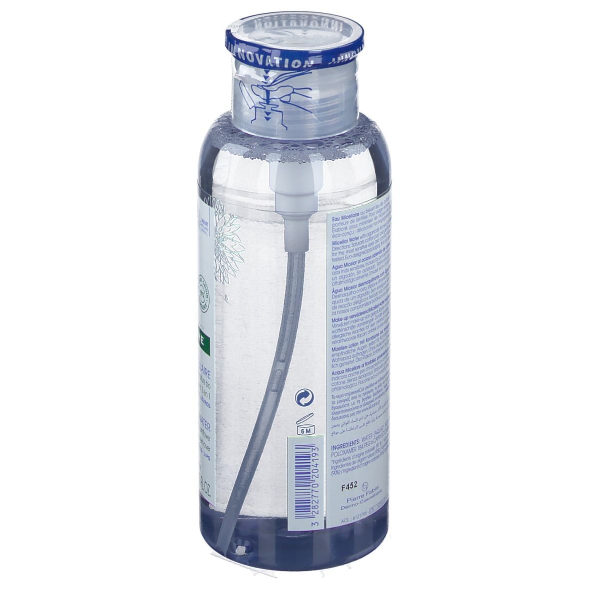 Flacon transparent avec liquide bleu et pompe. Étiquette avec texte et code-barres. Bouchon avec bande bleue.