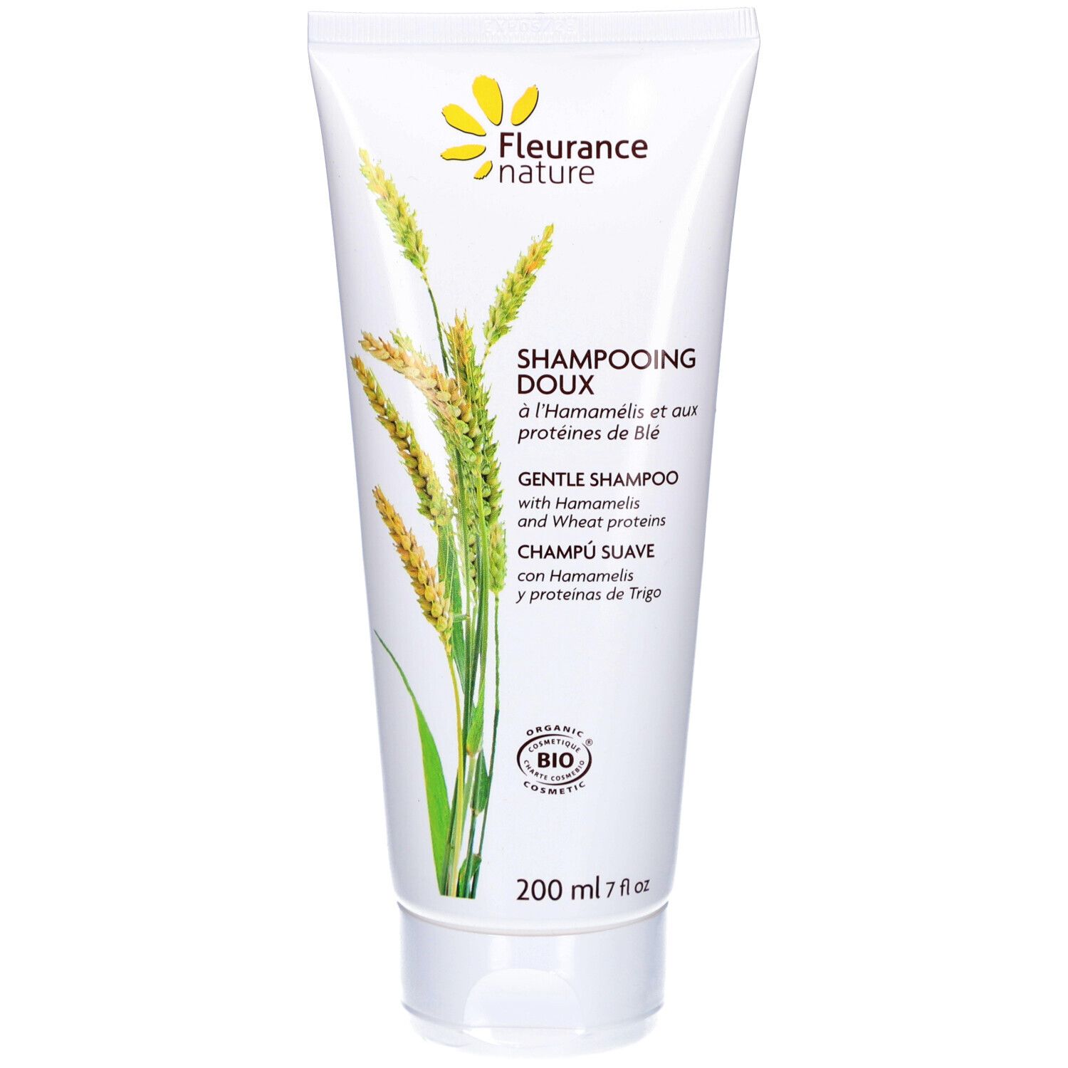 Tube de shampooing blanc avec logo floral jaune. Texte : "Shampooing Doux" et "Gentle Shampoo". Certification bio.