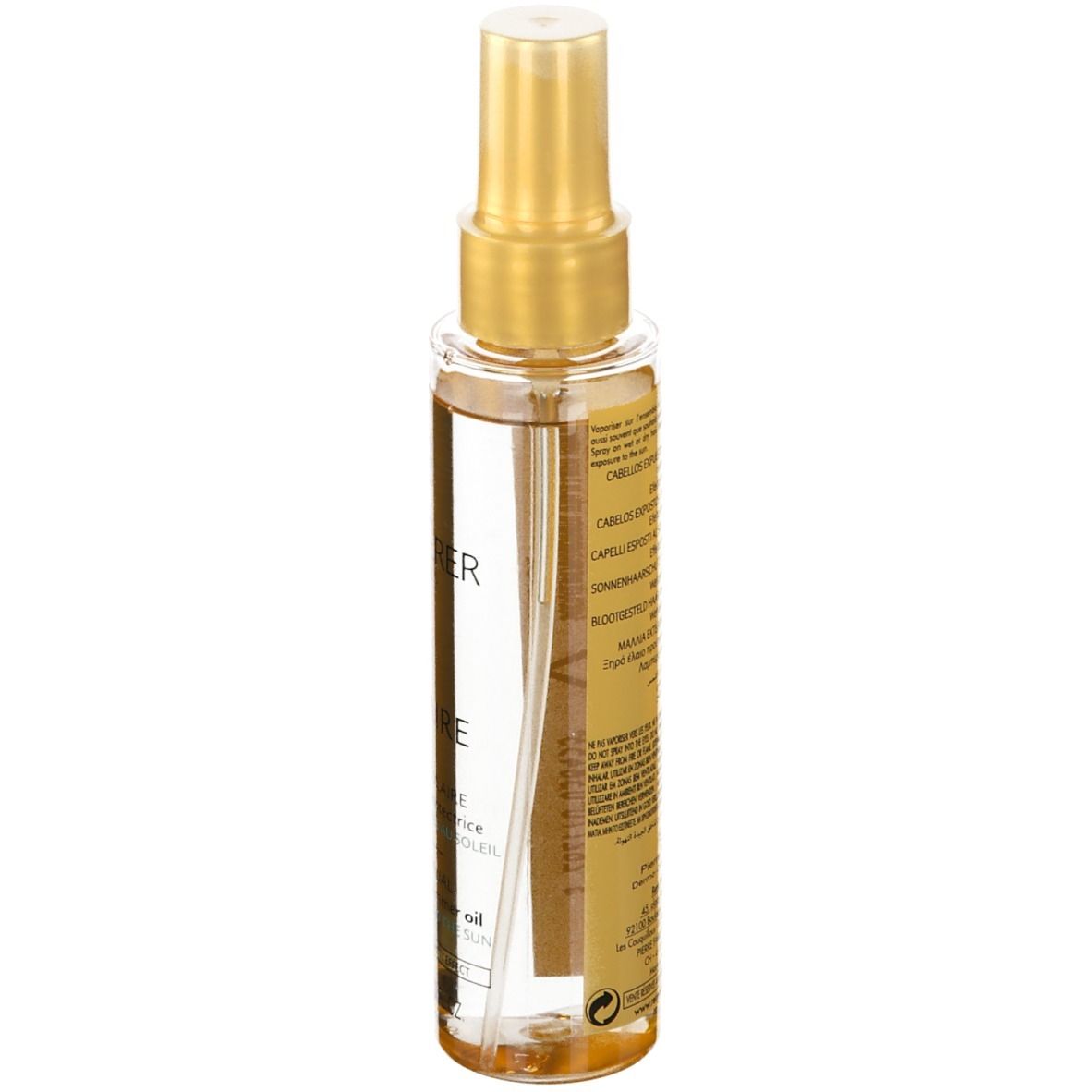 Flacon spray transparent avec bouchon doré. Dos avec texte. Huile solaire.