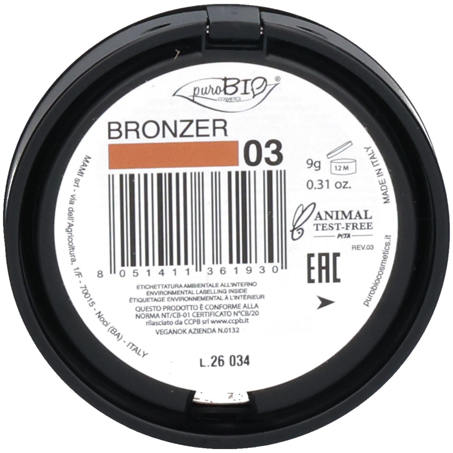 Boîtier rond avec bronzer. Contient le numéro "03". Code-barres et informations de taille et de durabilité également visibles.