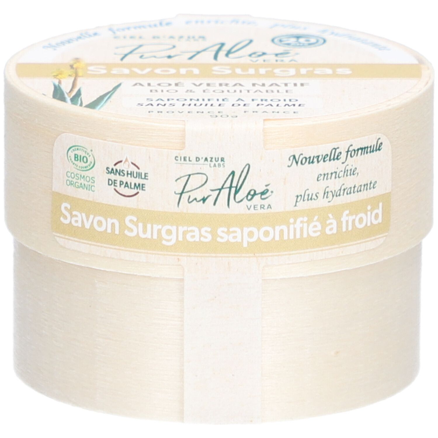 Boîte ronde avec "Savon Surgras". Étiquette "PurAloé" et label bio. Texte : "Nouvelle formule, enrichie, plus hydratante".