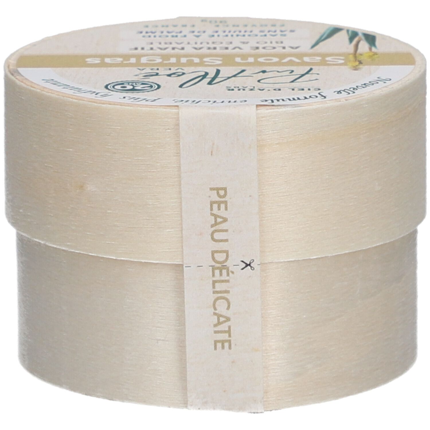 Boîte ronde avec "Savon Surgras". Étiquette "PurAloé" et label bio. Inscription "Peau délicate". Texte : "Nouvelle formule, enrichie, plus hydratante".