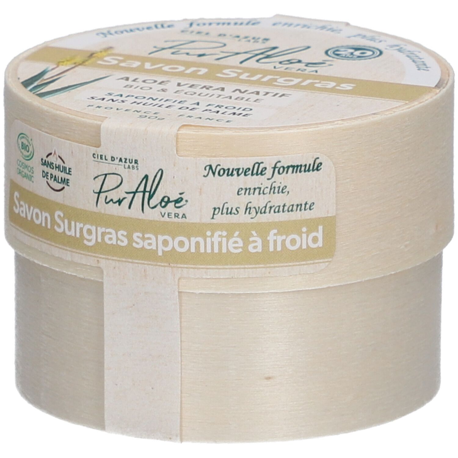 Boîte ronde avec "Savon Surgras". Étiquette "PurAloé" et label bio. Texte : "Nouvelle formule, enrichie, plus hydratante".