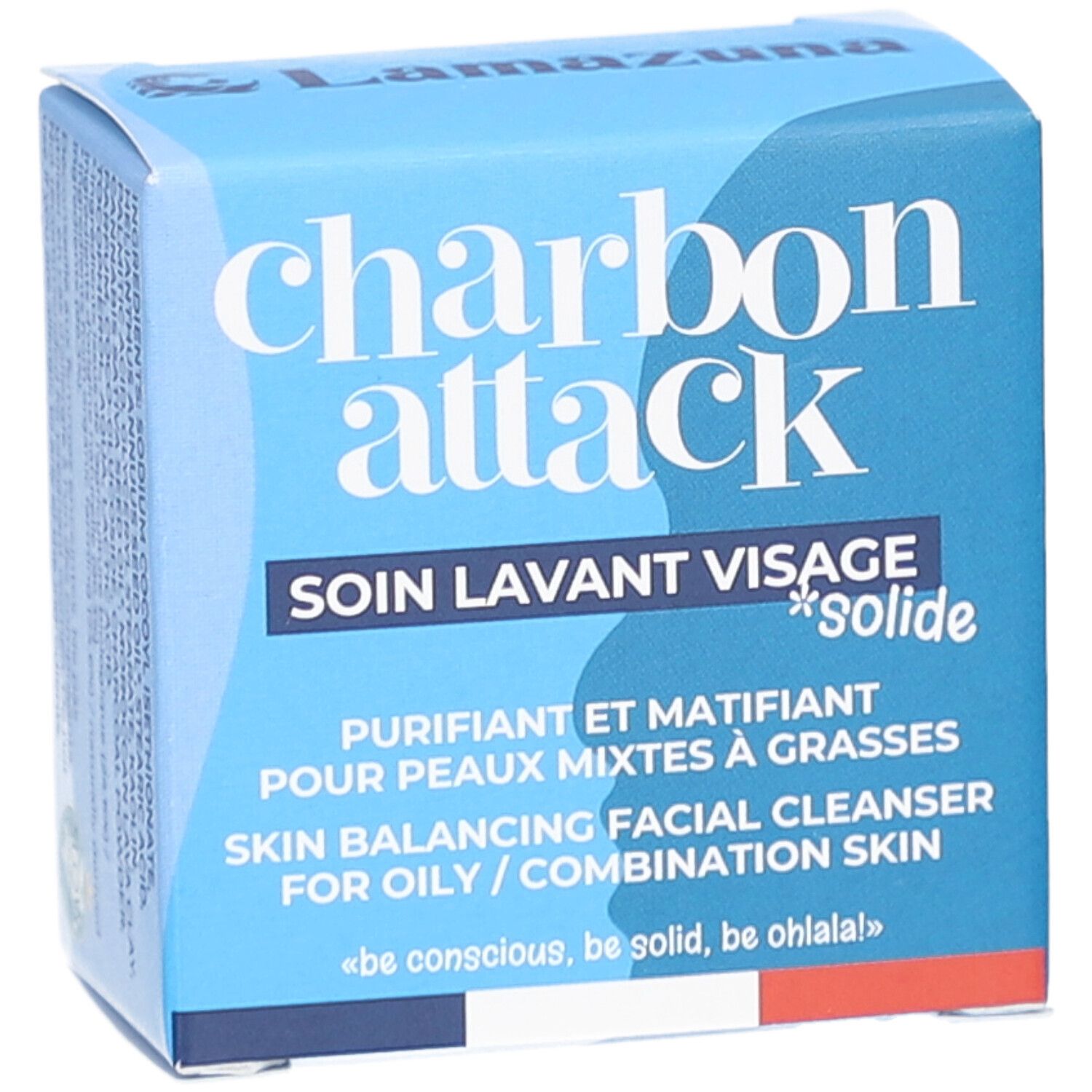 Boîte bleue avec "charbon attack" et "soin lavant visage solide". Texte en français et anglais. Logo de la marque.