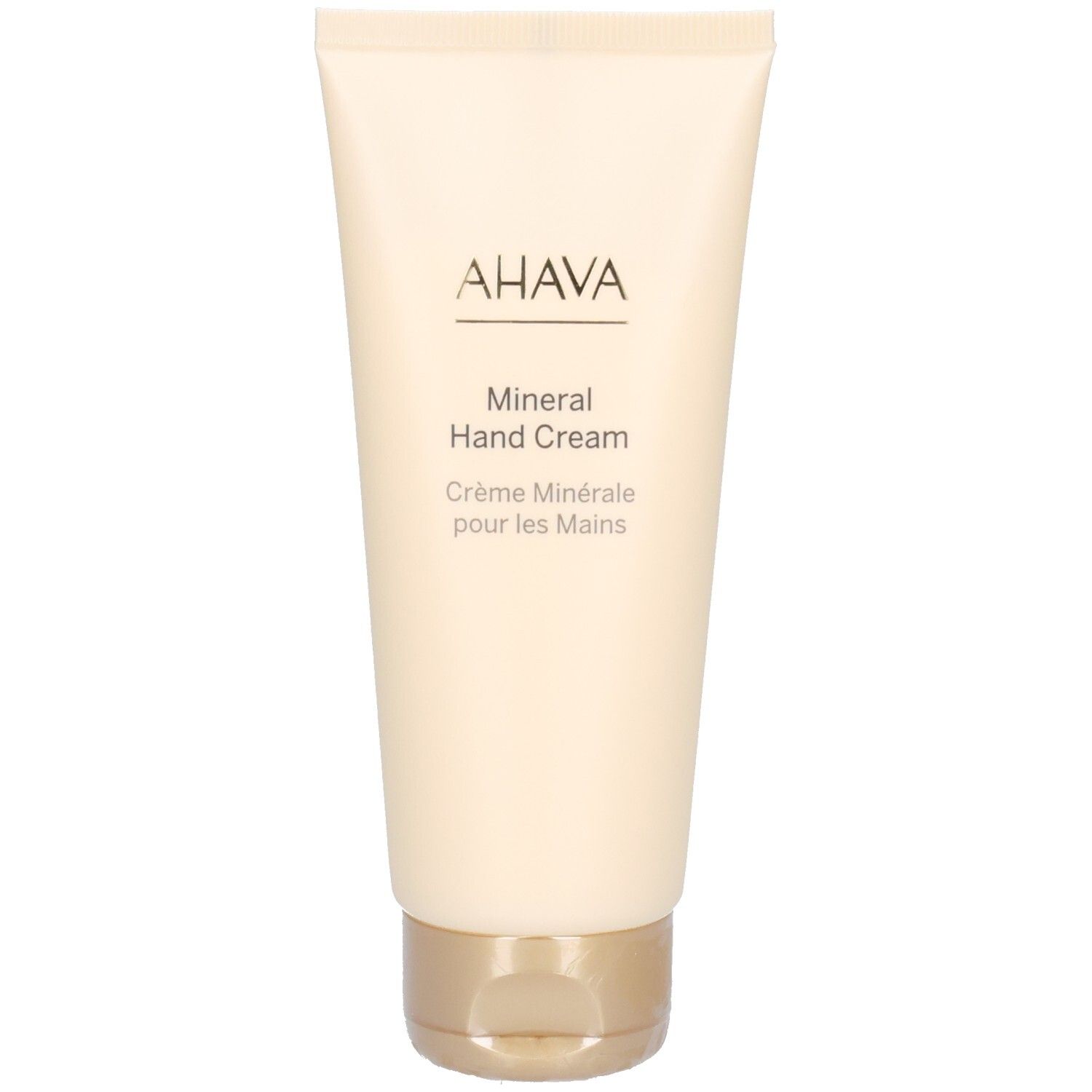 Tube beige avec bouchon doré. Inscription: AHAVA, Mineral Hand Cream, Crème Minérale pour les Mains.