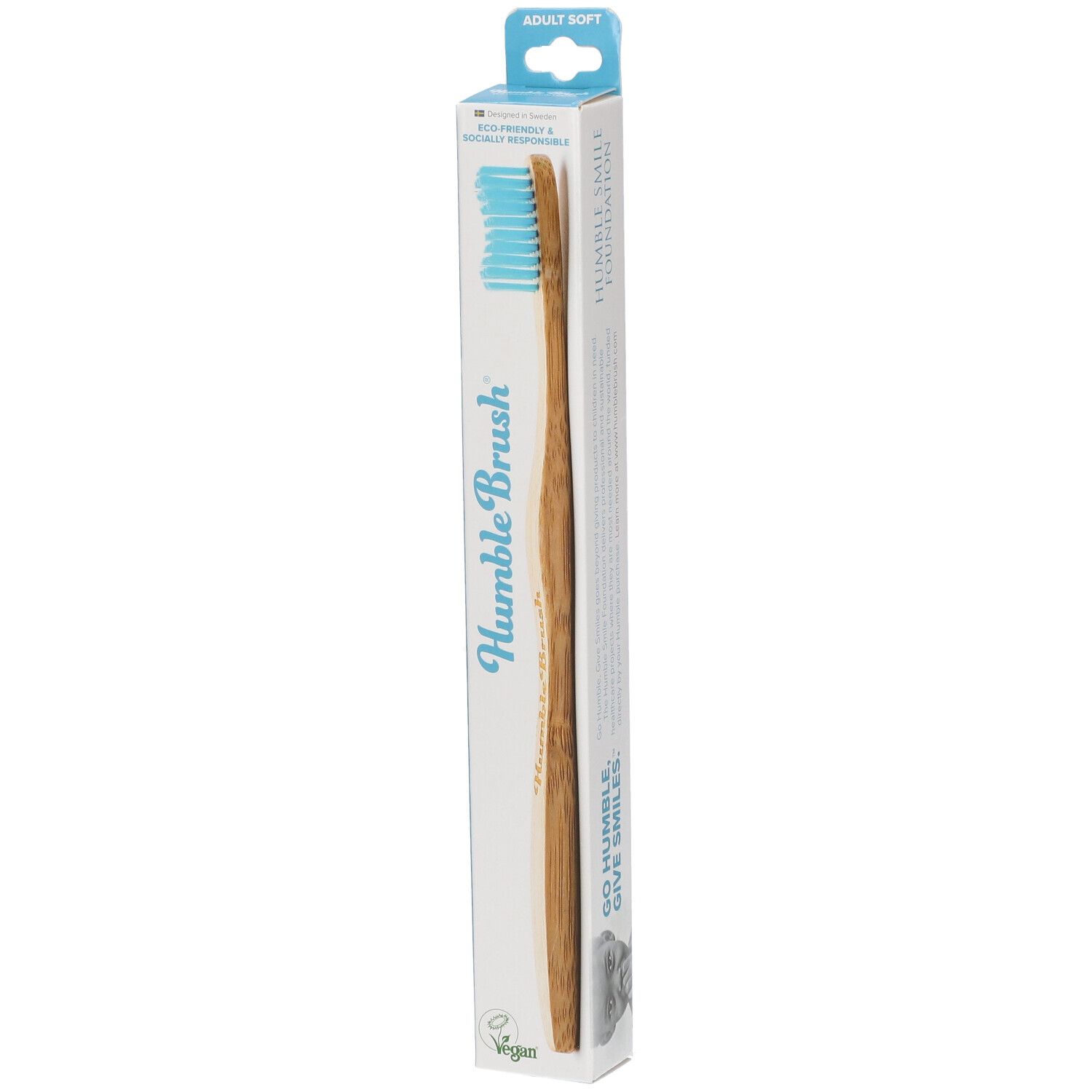 Brosse à dents bleue dans son emballage. Inscription: Humble Brush, Adult Soft, Vegan.