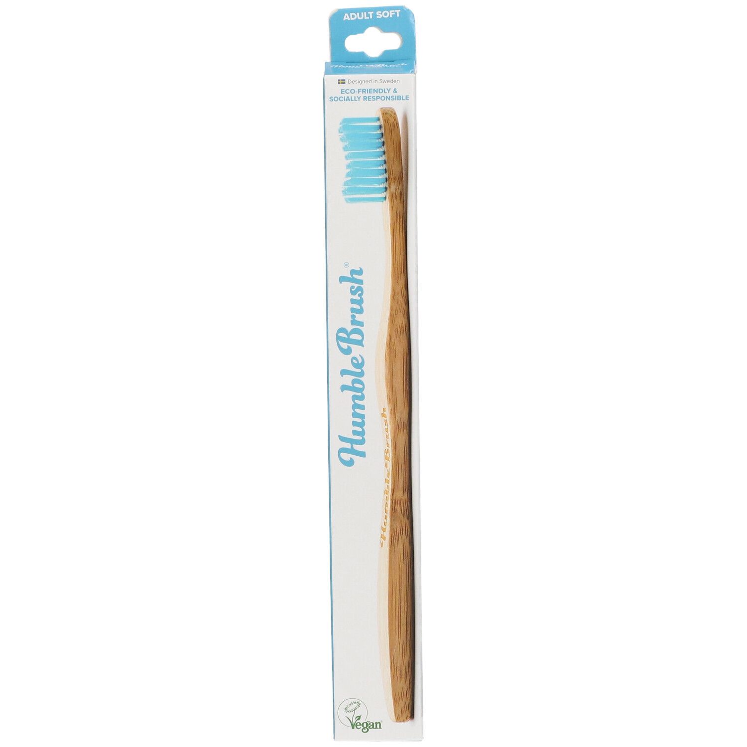 Brosse à dents bleue dans son emballage. Inscription: Humble Brush, Adult Soft, Vegan.