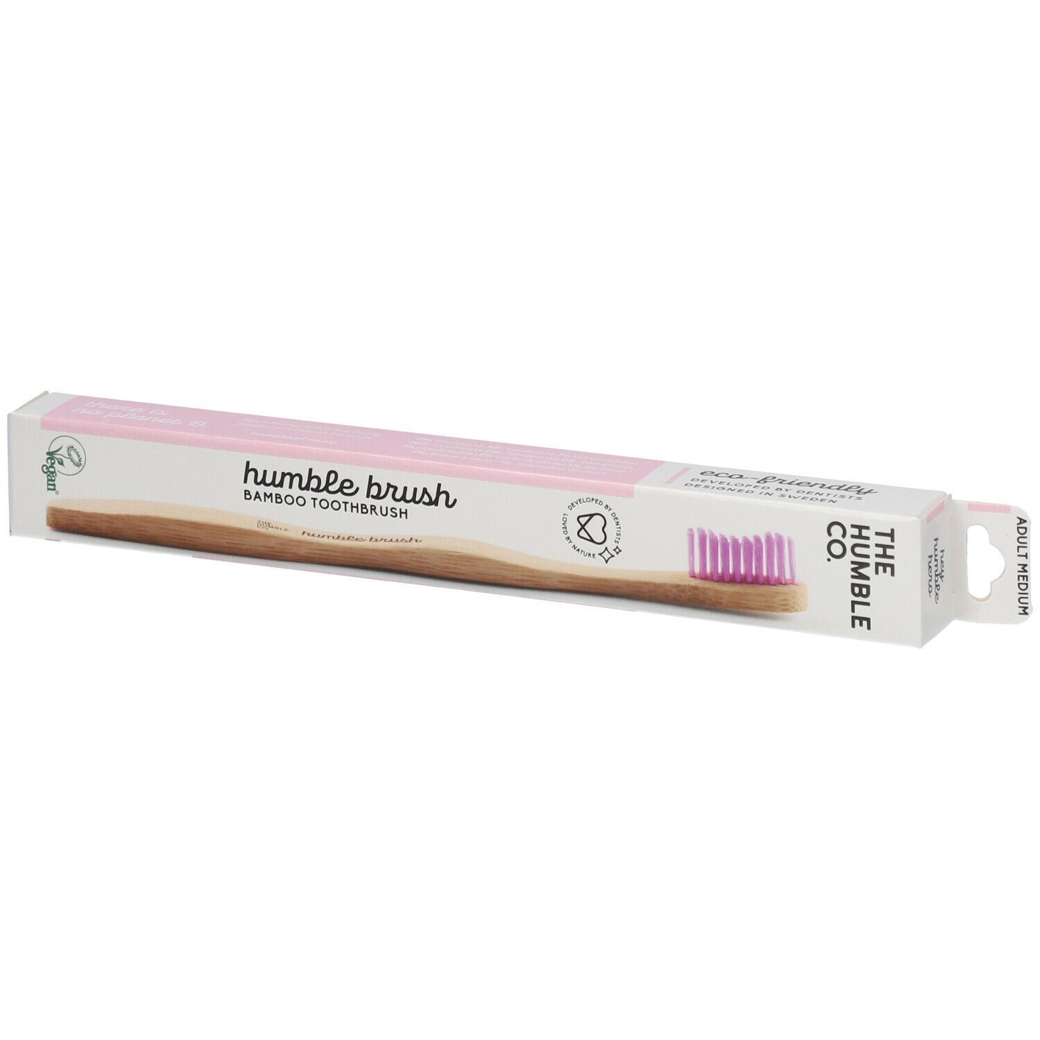 Brosse à dents dans son emballage. Soies roses, manche en bambou, emballage avec logo et texte. Label vegan.