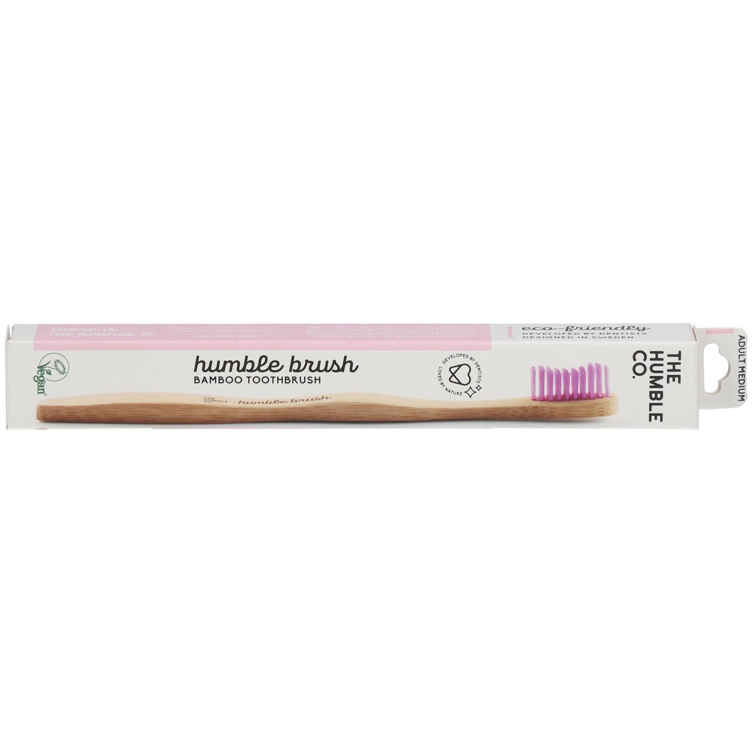 Brosse à dents dans son emballage. Soies roses, manche en bambou, emballage avec logo et texte. Label vegan.