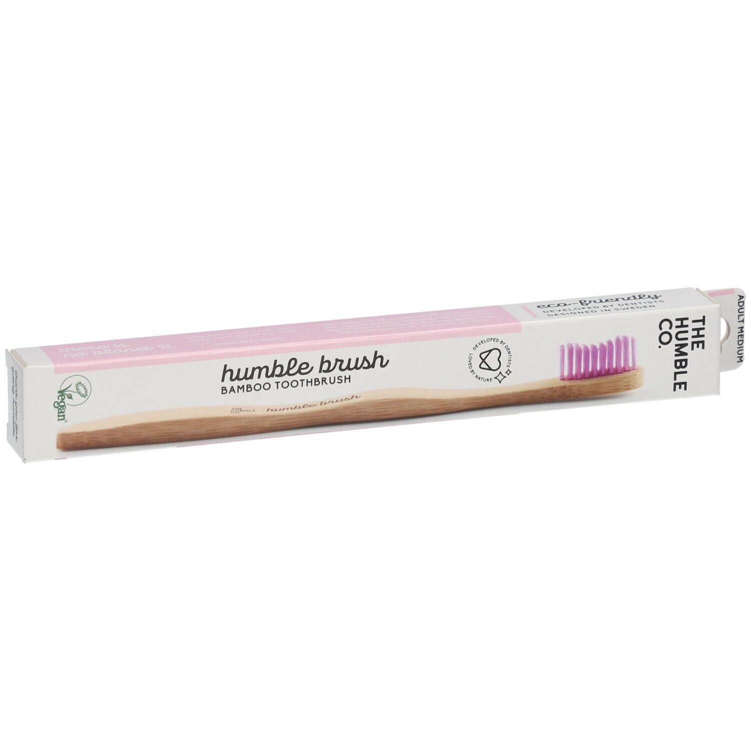 Brosse à dents dans son emballage. Soies roses, manche en bambou, emballage avec logo et texte. Label vegan. Vue en angle.