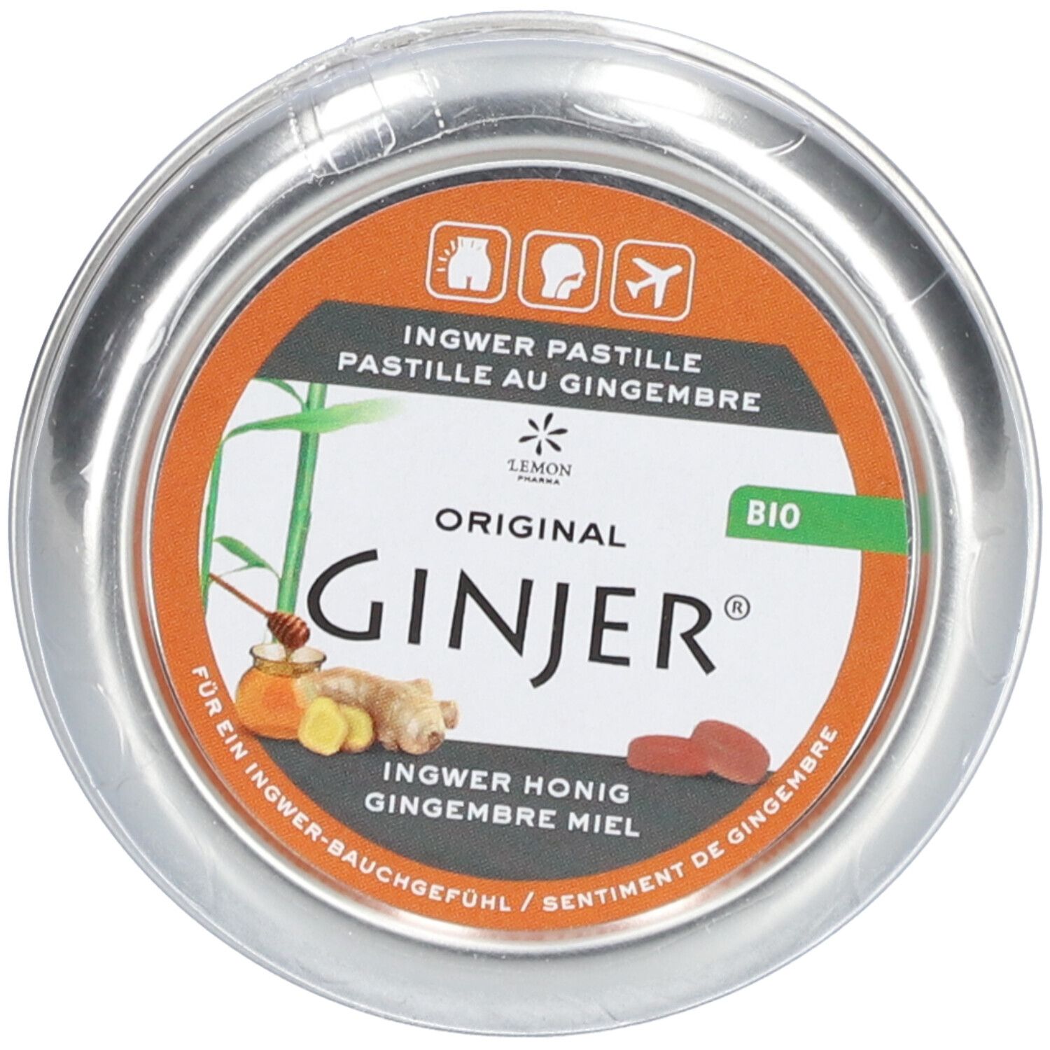 Boîte ronde avec inscription "GINJER". Couvercle orange avec informations produit et label bio.