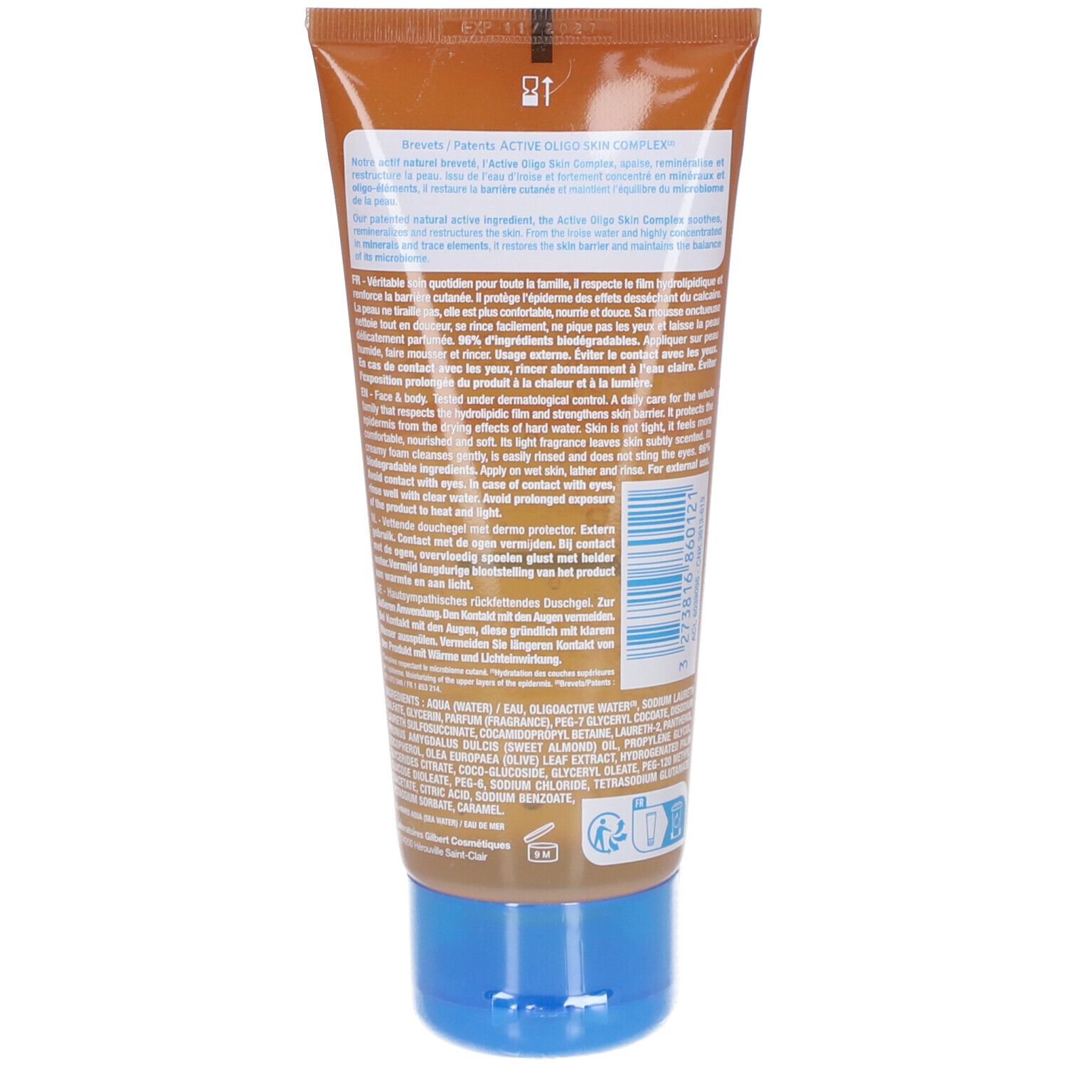 Dos du tube. Texte multilingue. Bouchon bleu. Fond marron.