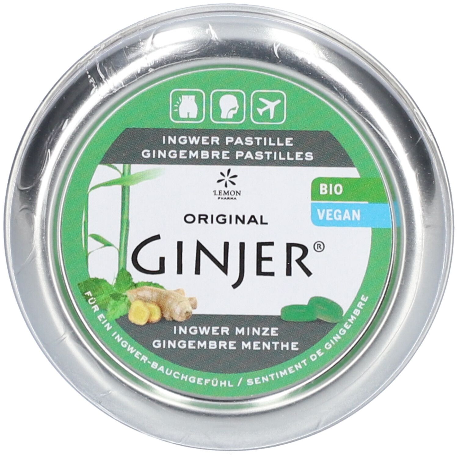Boîte ronde avec étiquette verte. Inscription: Ginjer Pastilles. Labels Bio et Vegan. Illustration de gingembre et menthe.