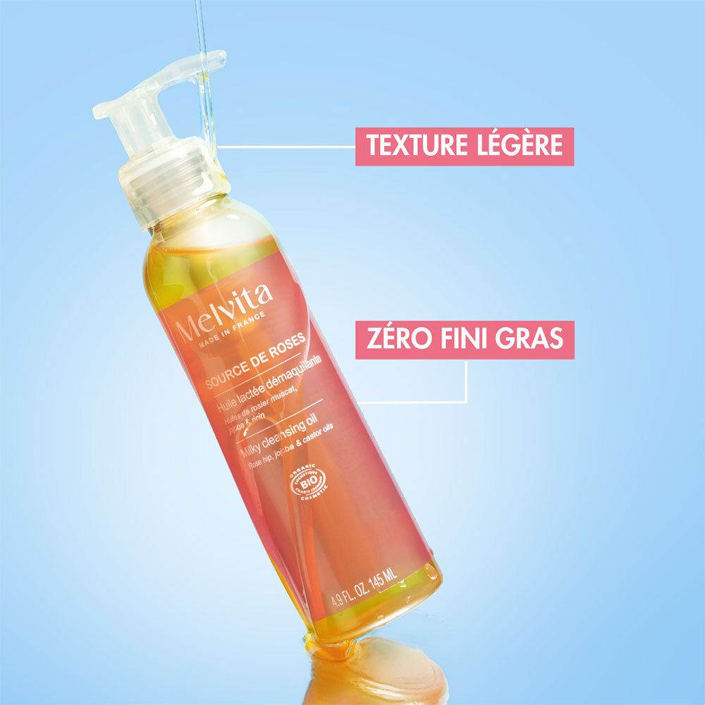 Flacon avec pompe, liquide jaunâtre. Texte: Melvita, Source de Roses. Texte: Texture légère, zéro fini gras.