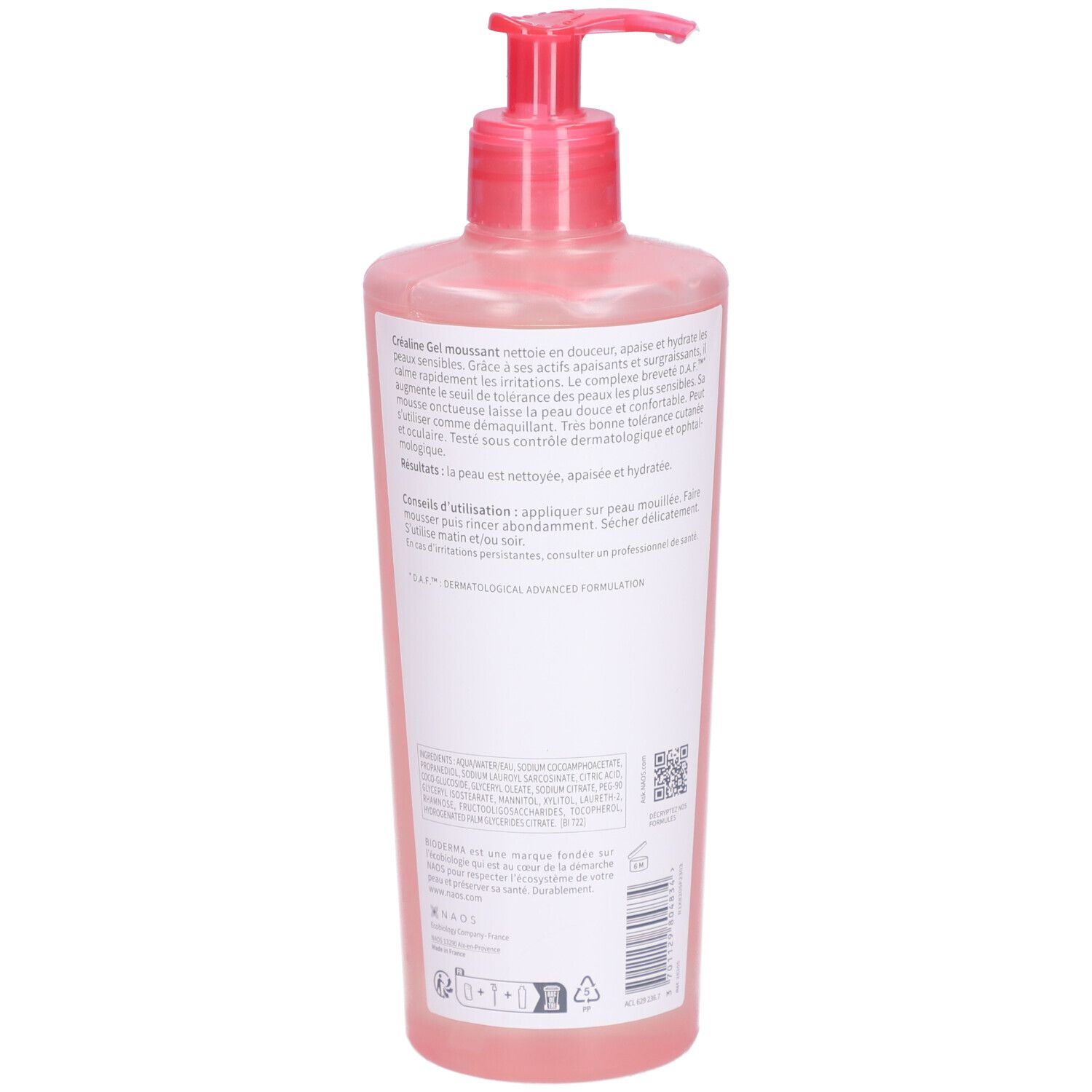 Vue arrière du flacon rose avec pompe. Texte sur l'étiquette. Informations et instructions d'utilisation.