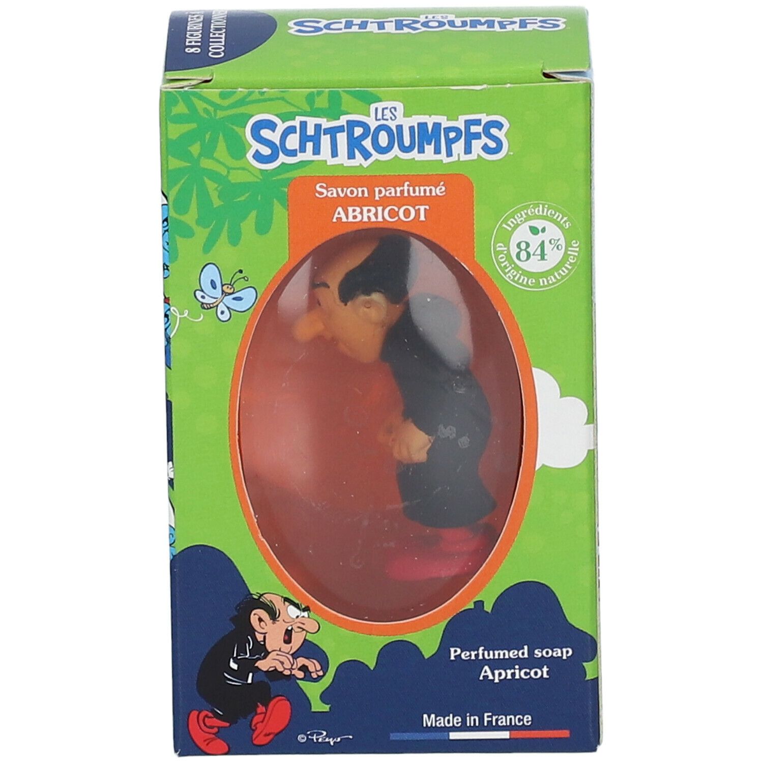 Savon parfumé Abricot avec figurine Gargamel dans boîte. Boîte verte avec texte et illustrations. Produit visible à travers fenêtre.
