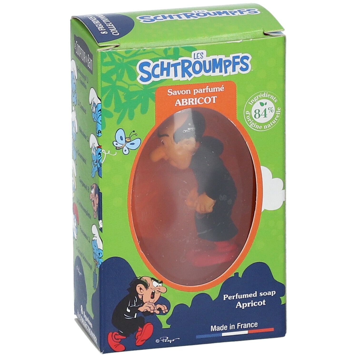 Savon parfumé Abricot avec figurine Gargamel dans boîte. Boîte verte avec texte et illustrations. Produit visible à travers fenêtre.