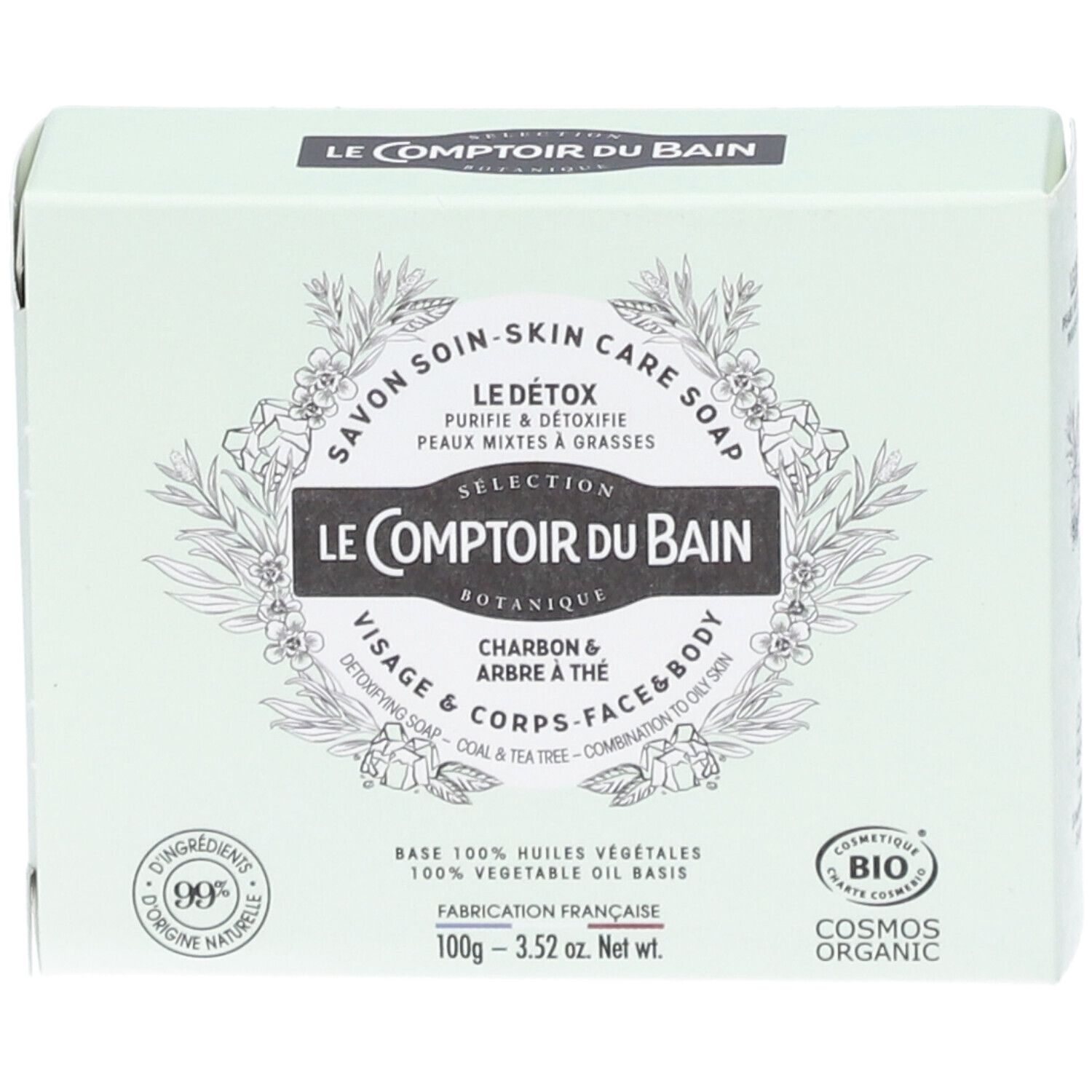 Boîte vert clair avec informations produit. Inscriptions: Le Comptoir du Bain, Le Détox, Charbon & Arbre à thé. Certification Cosmos Organic.