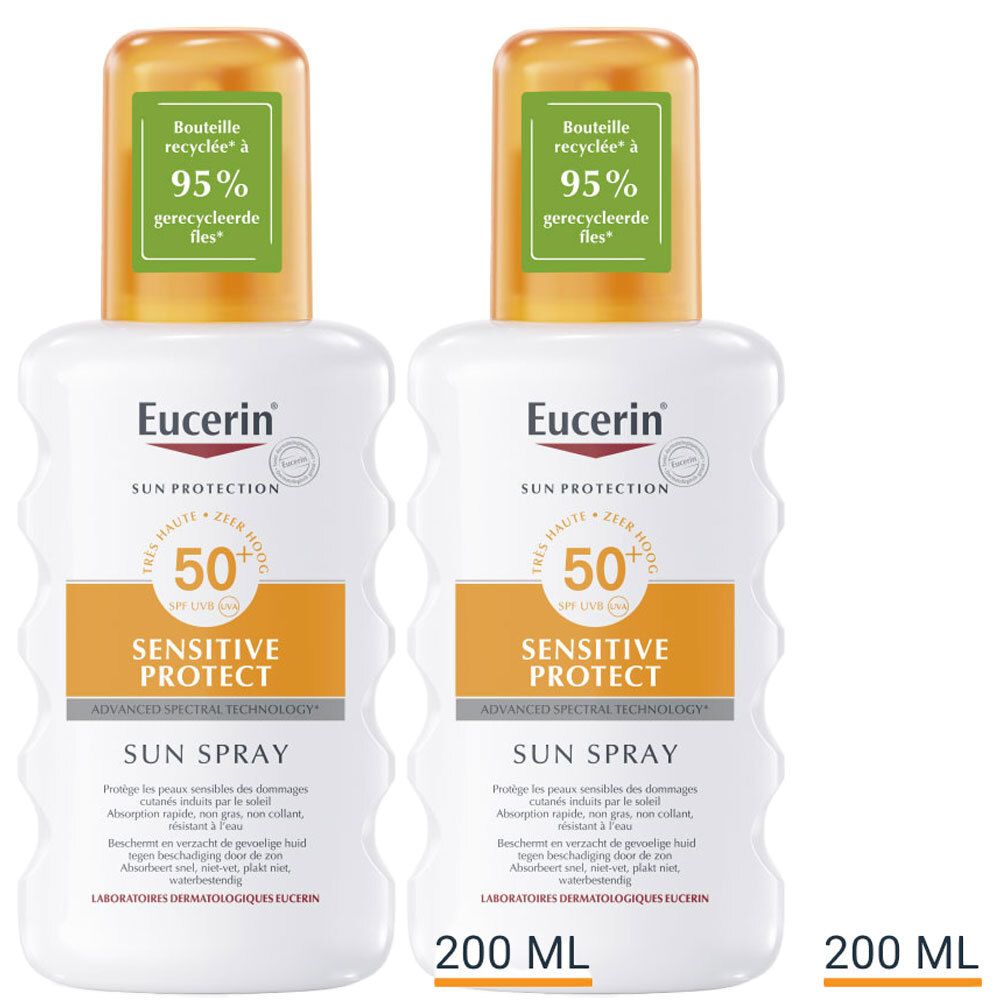 Deux flacons spray blancs avec détails orange. Inscriptions: Eucerin, Sun Protection, Sensitive Protect, Sun Spray, SPF 50+. 200 ml. Bouteilles recyclées.