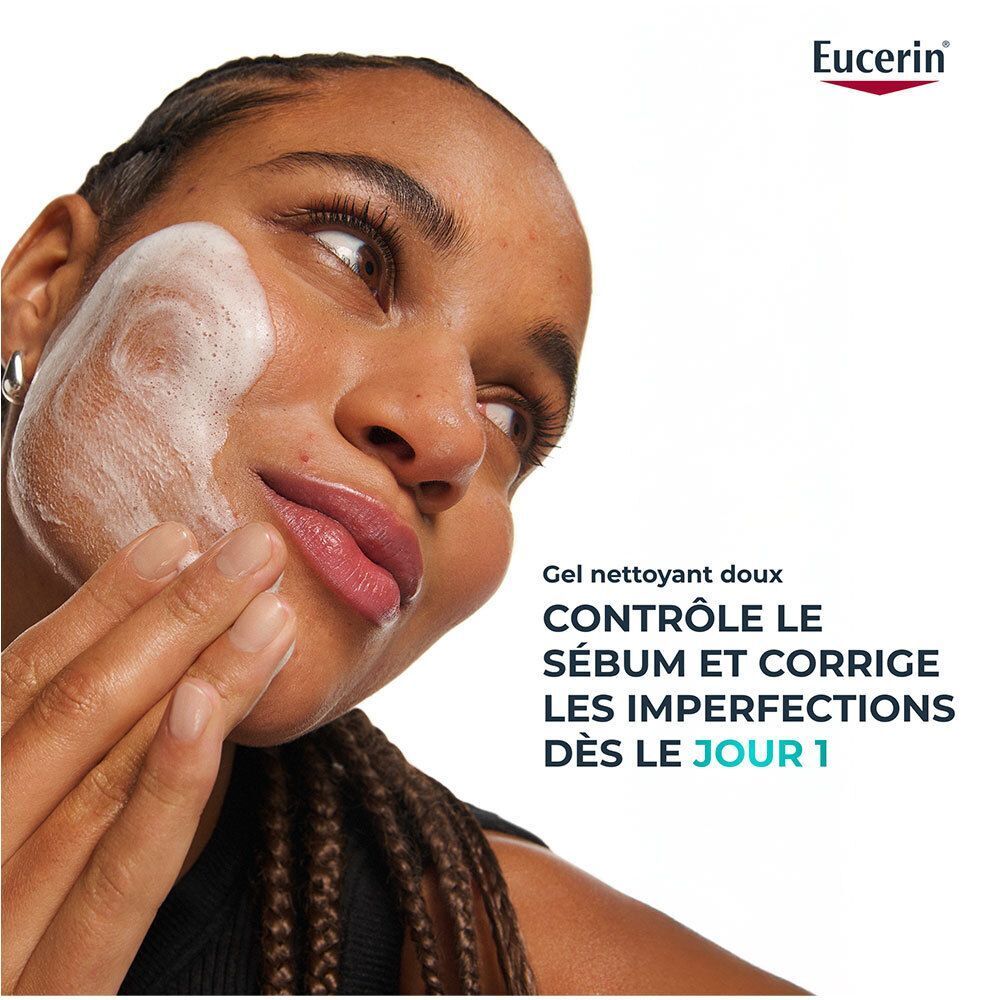 Une femme nettoie son visage avec le Gel Nettoyant Eucerin DermoPure, produisant de la mousse.