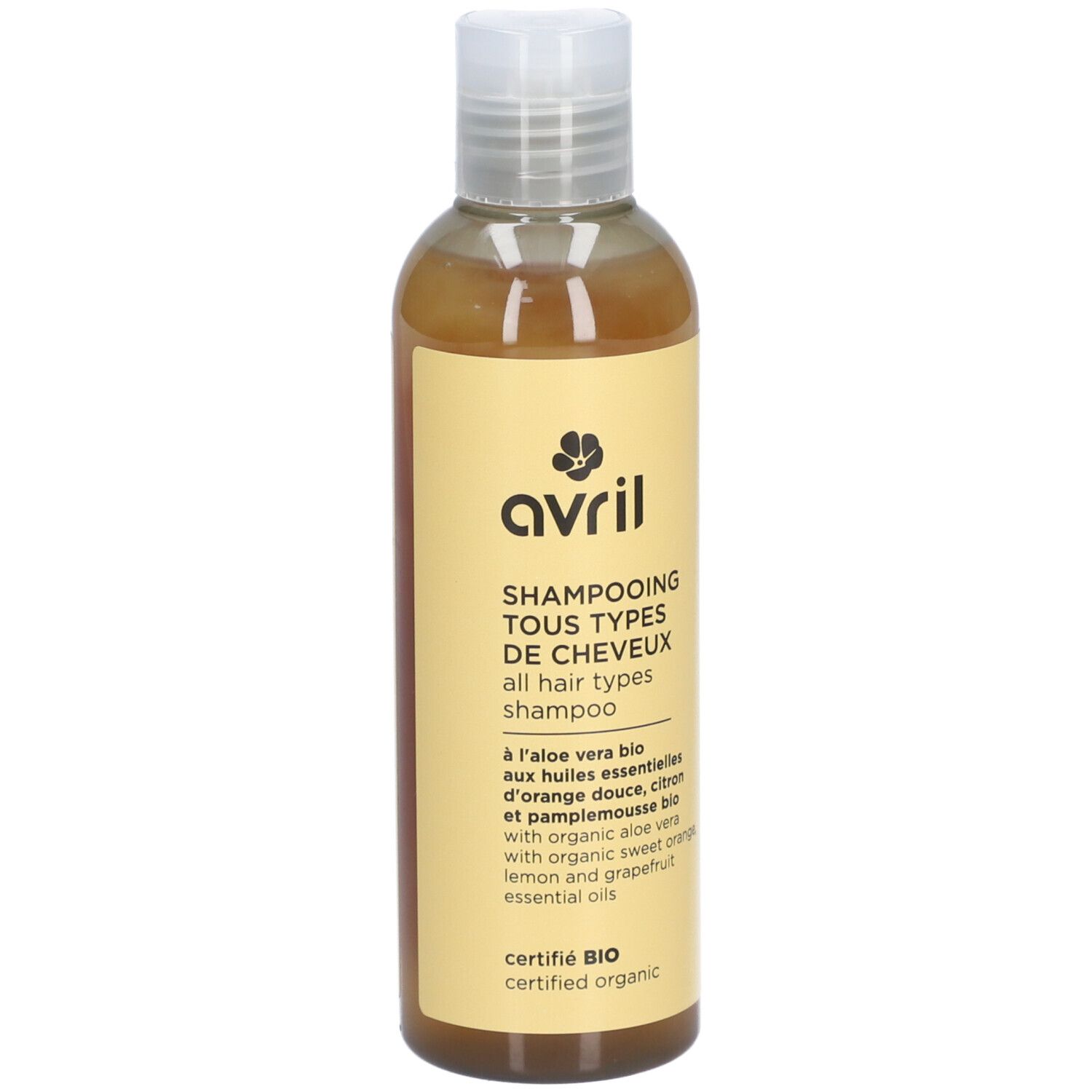 Flacon de Shampooing Tous Types de Cheveux. Étiquette jaune avec logo et informations. Certifié BIO, contient aloe vera.