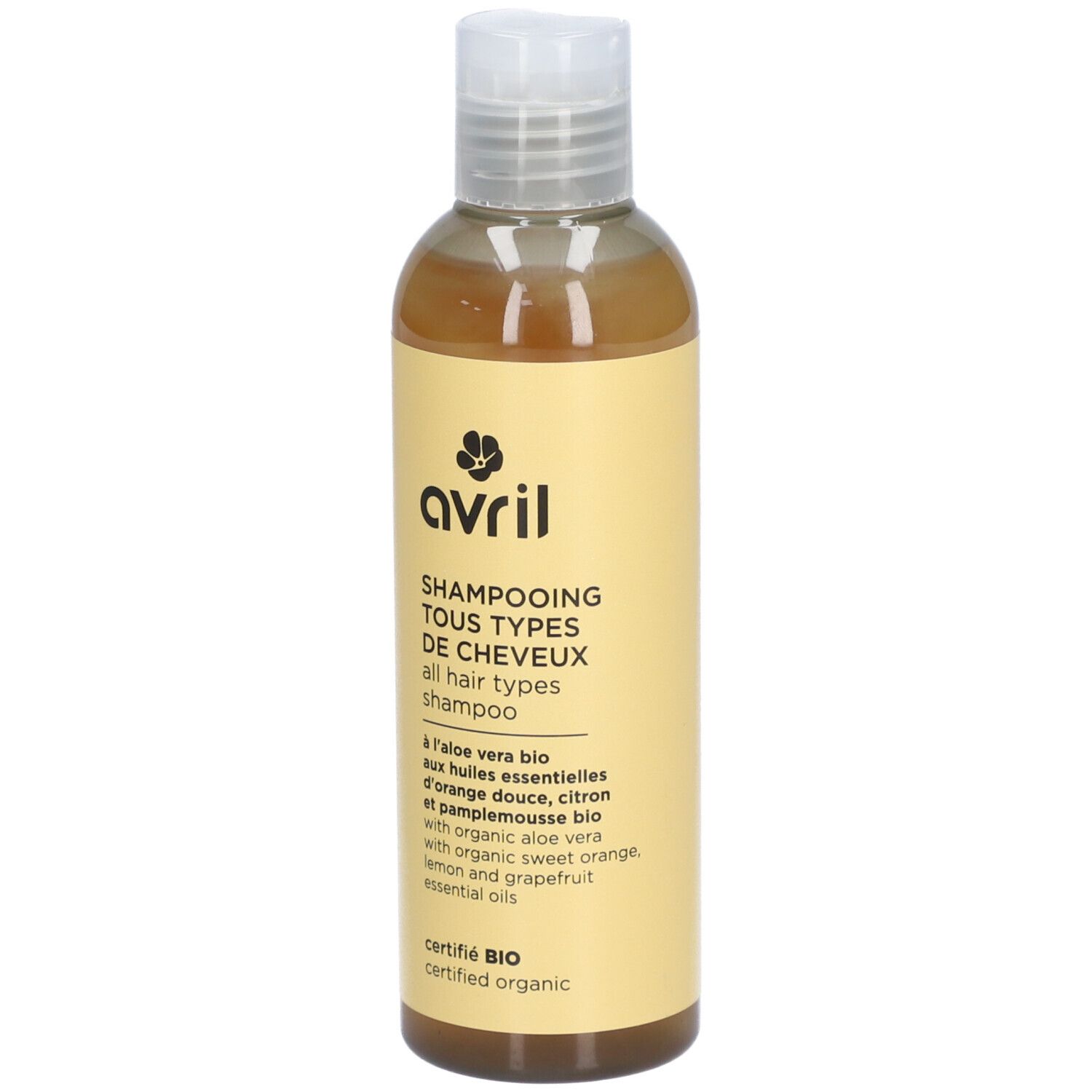 Flacon de Shampooing Tous Types de Cheveux. Étiquette jaune avec logo et informations. Certifié BIO, contient aloe vera.