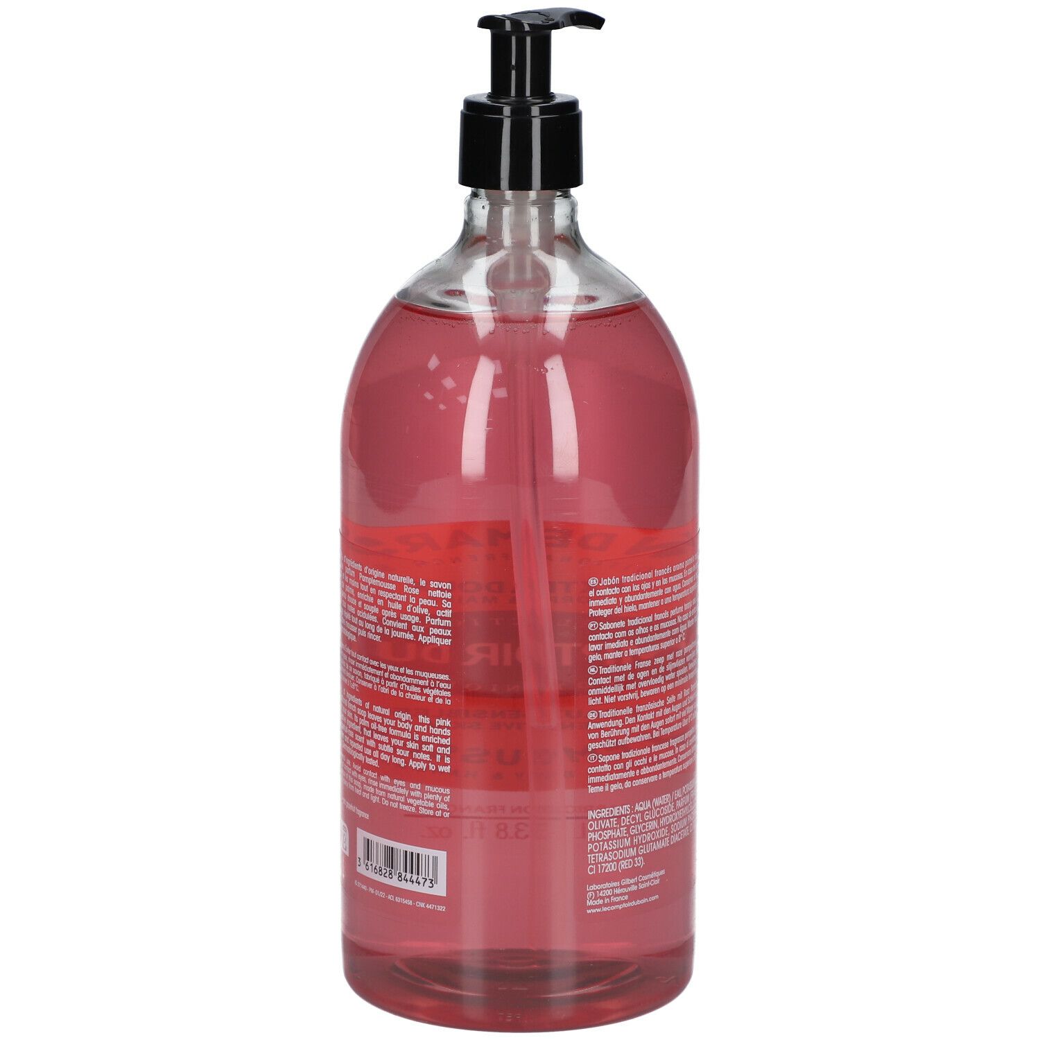 Dos du flacon transparent de savon liquide rose. Texte sur l'étiquette, pompe noire.