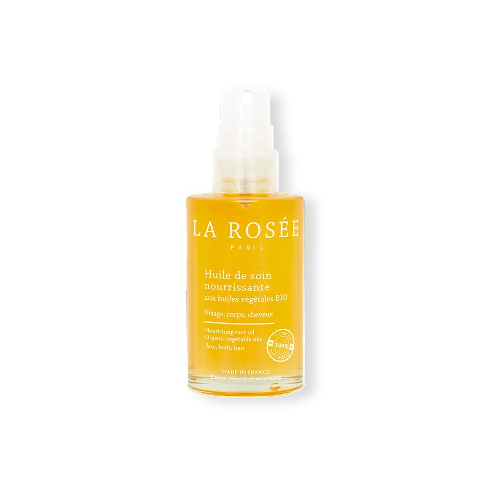 Flacon transparent d'huile jaune avec vaporisateur. Inscription: LA ROSÉE, Huile de soin nourrissante, Bio.