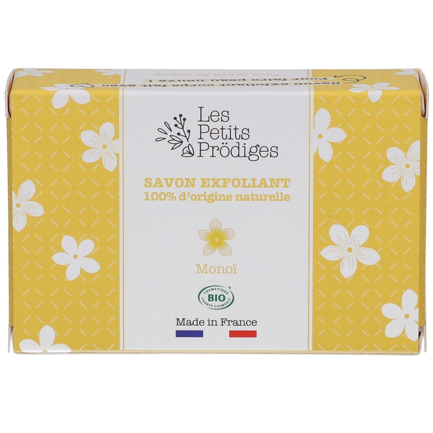 Boîte jaune à motifs floraux blancs. Inscription: SAVON EXFOLIANT, 100% d'origine naturelle, Monoi, BIO. Drapeau français.