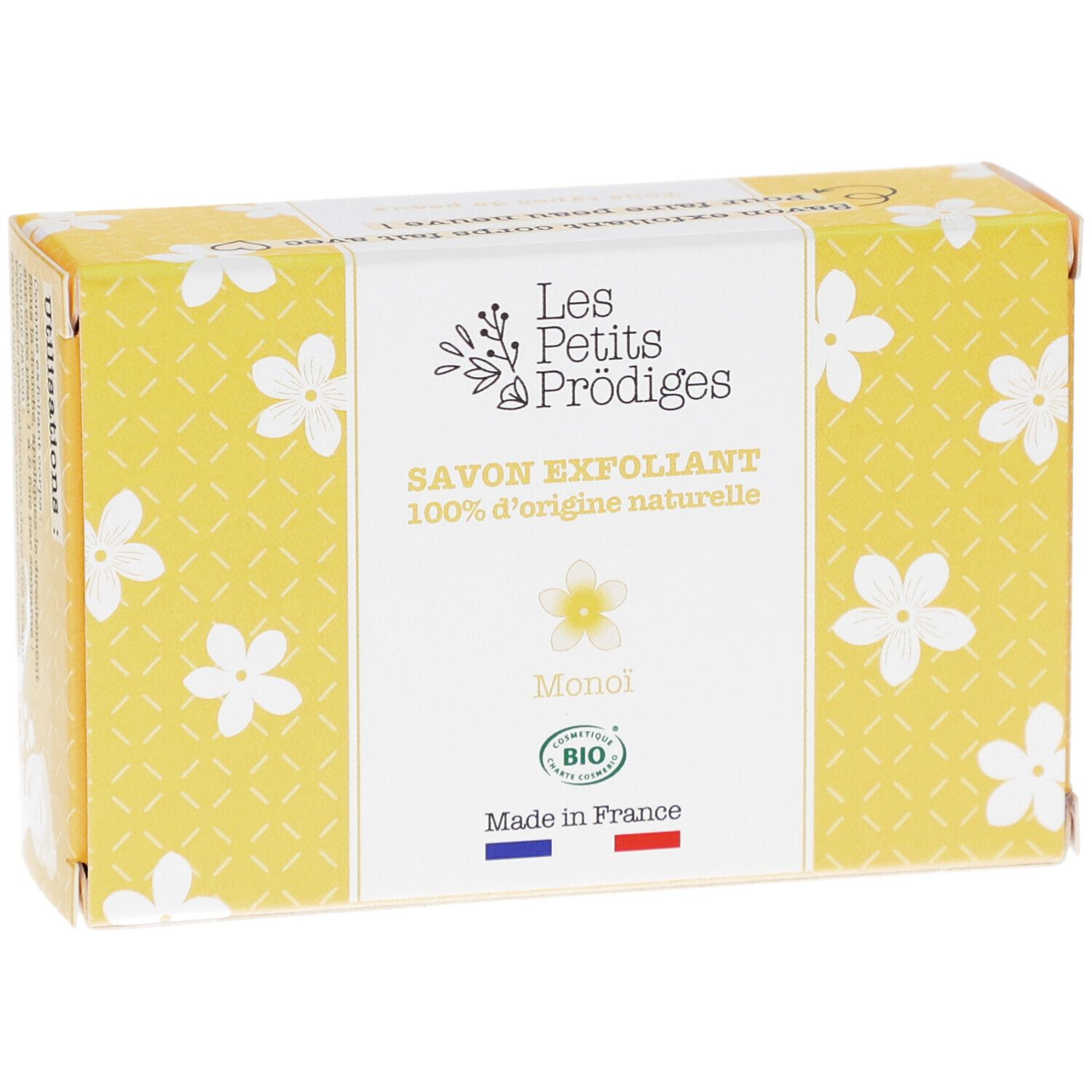 Boîte jaune à motifs floraux blancs. Inscription: SAVON EXFOLIANT, 100% d'origine naturelle, Monoi, BIO. Drapeau français.