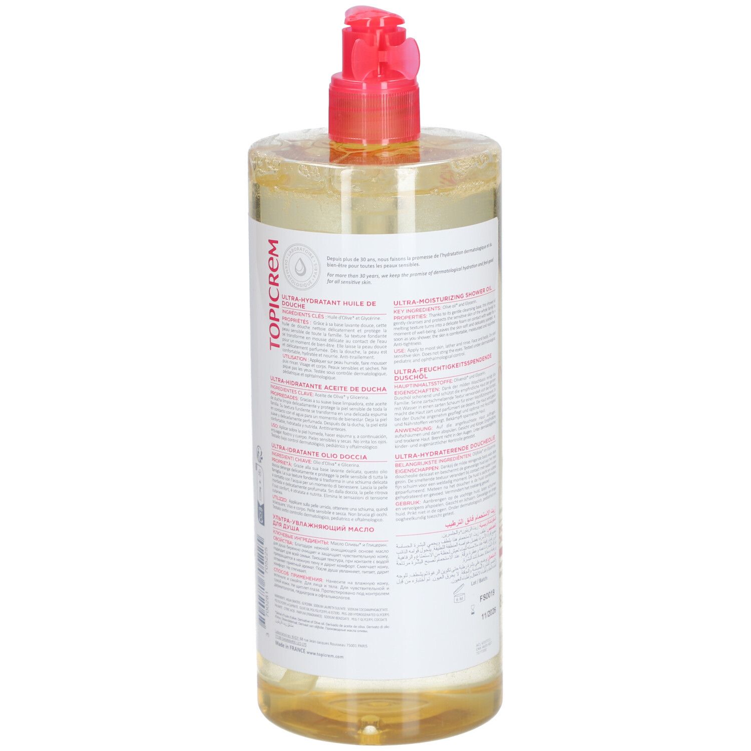 Flacon transparent avec liquide jaunâtre. Bouchon pompe rose. Dos avec texte en plusieurs langues. Marque : Topicrem.