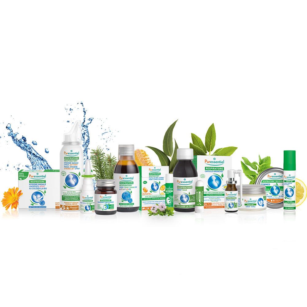 Divers produits de soins pour bébés. Spray nasal, sirop, crèmes et autres produits sur fond blanc.