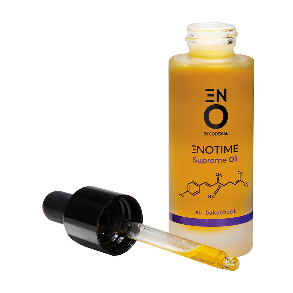 Flacon d'huile jaune, pipette noire. Pipette à côté. Inscription : Enotime Supreme Oil.