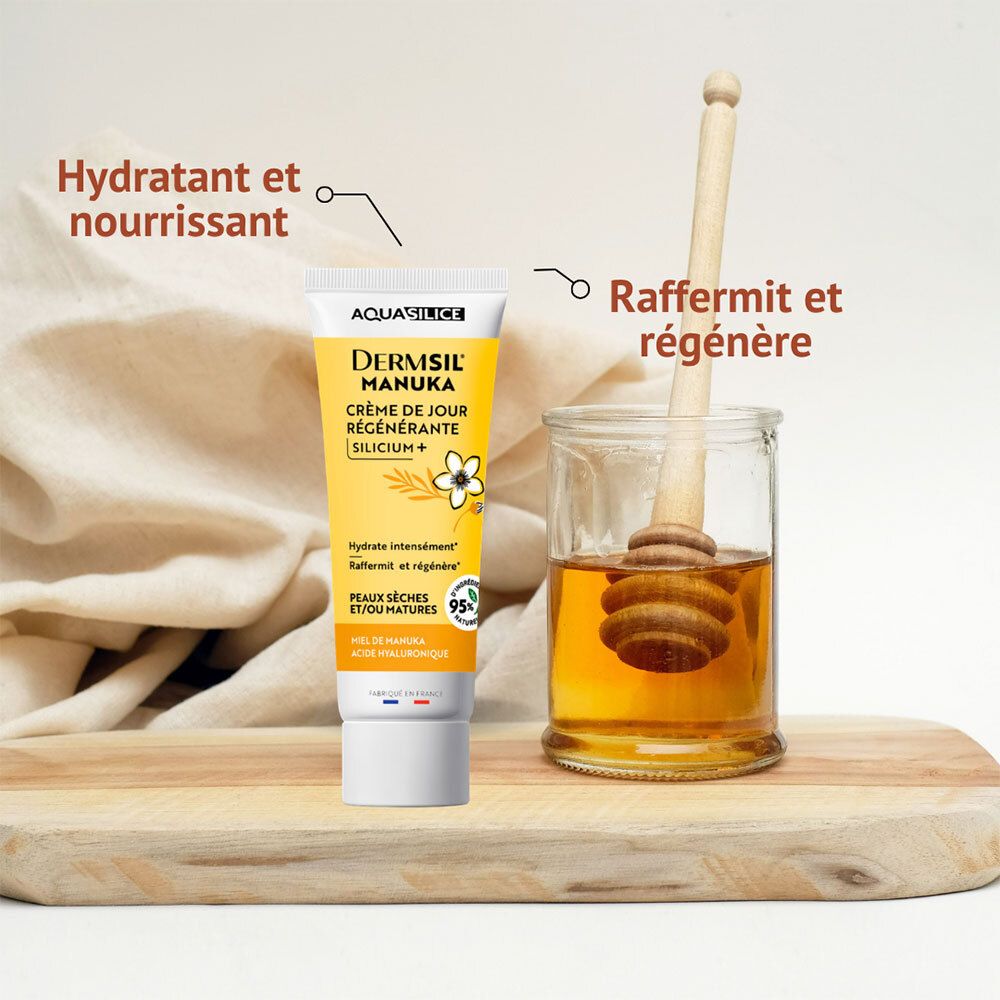 Tube de crème AQUASILICE DERMSIL MANUKA à côté d'un pot de miel avec un bâton à miel. Texte en français.