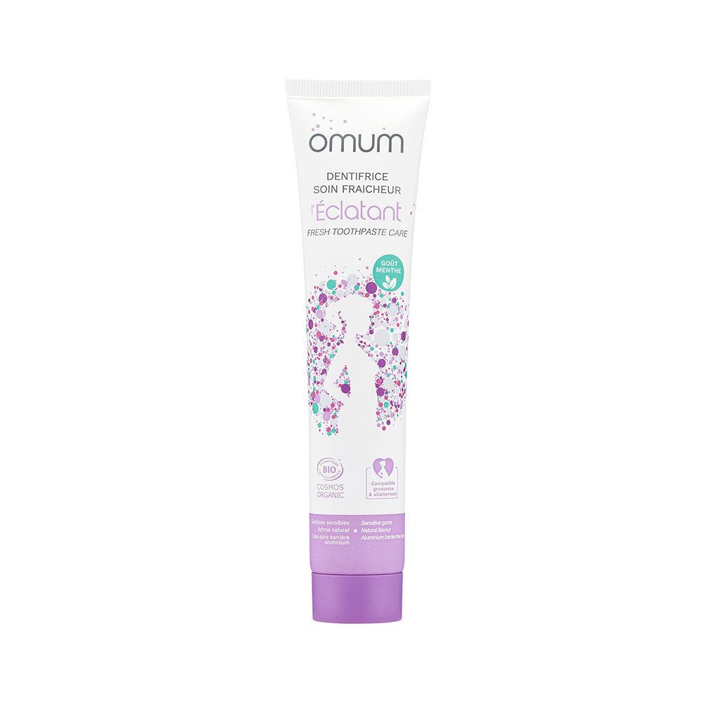 Tube de dentifrice Omum L'Eclatant avec bouchon violet et design floral.