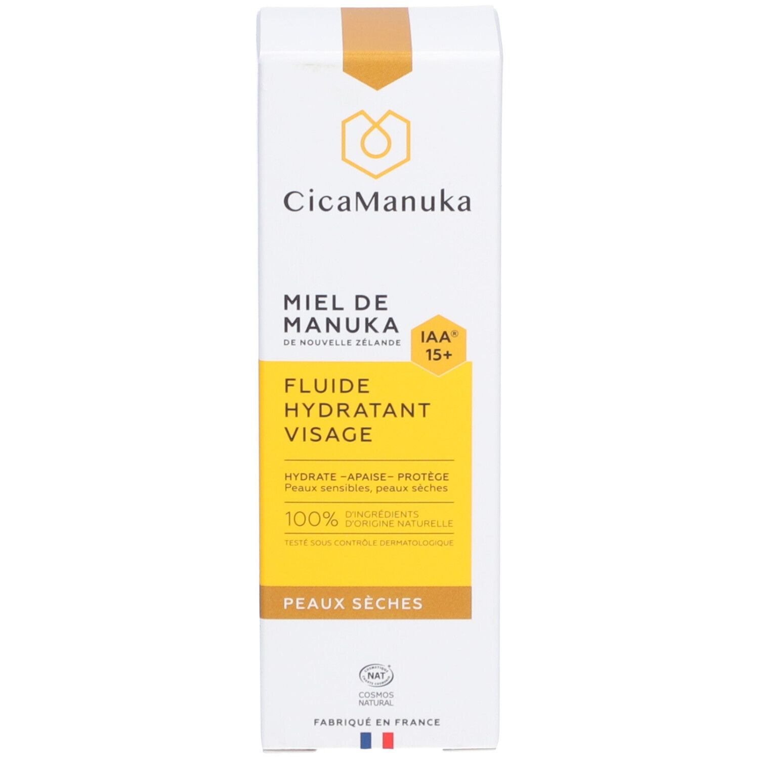 Boîte blanche avec étiquette jaune. Inscription: CicaManuka, miel de Nouvelle-Zélande, IAA15+, fluide hydratant visage. 100% ingrédients naturels. Peaux sèches.