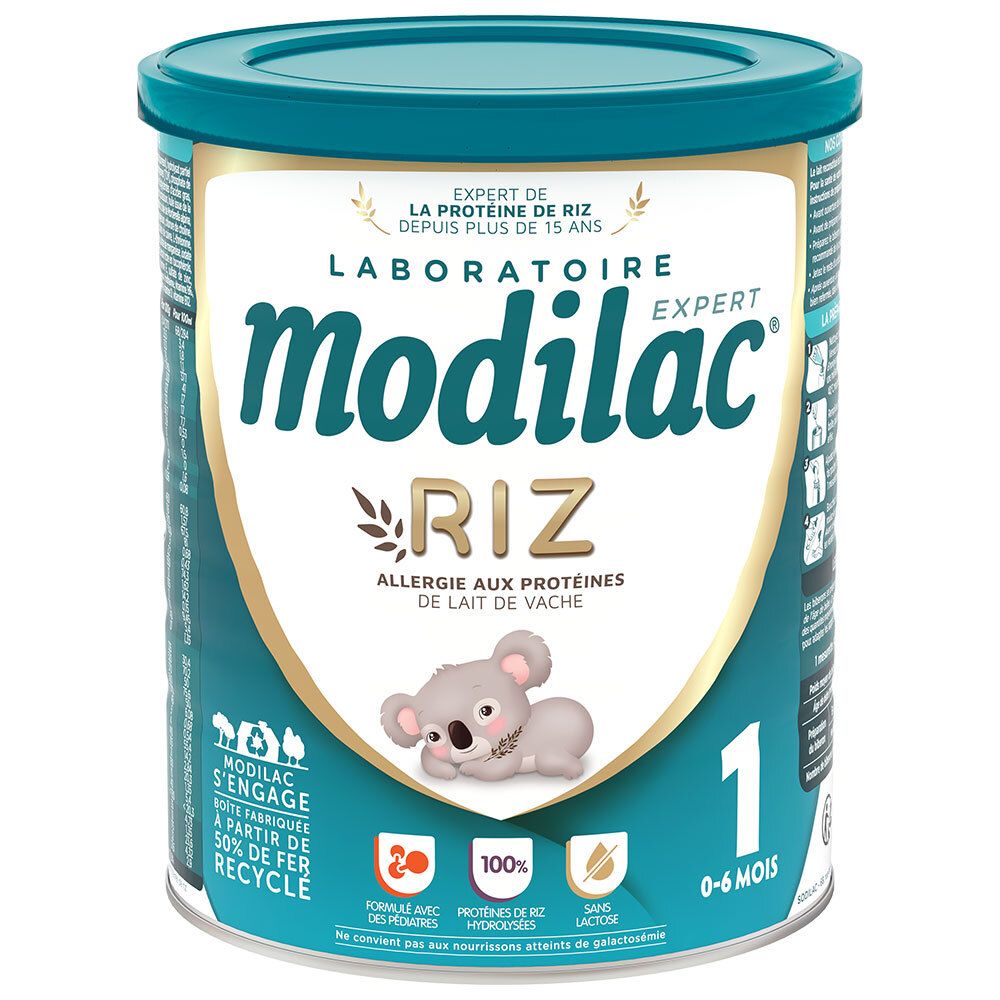 Boîte de lait Modilac Expert Riz 1er âge, 0-6 mois. Boîte bleue avec couvercle blanc. Informations produit et koala.