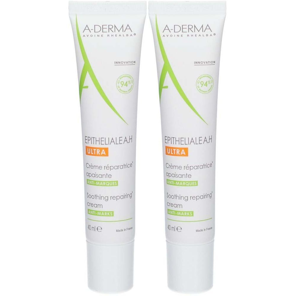 Deux tubes de crème A-DERMA EPITHELIALE A.H ULTRA. Tubes blancs avec accents verts et orange. Texte : Crème réparatrice apaisante.