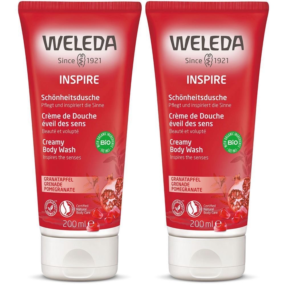 Deux tubes rouges avec bouchon blanc. Inscription: WELEDA, INSPIRE, Crème de Douche, Creamy Body Wash, Grenade. Label Bio.